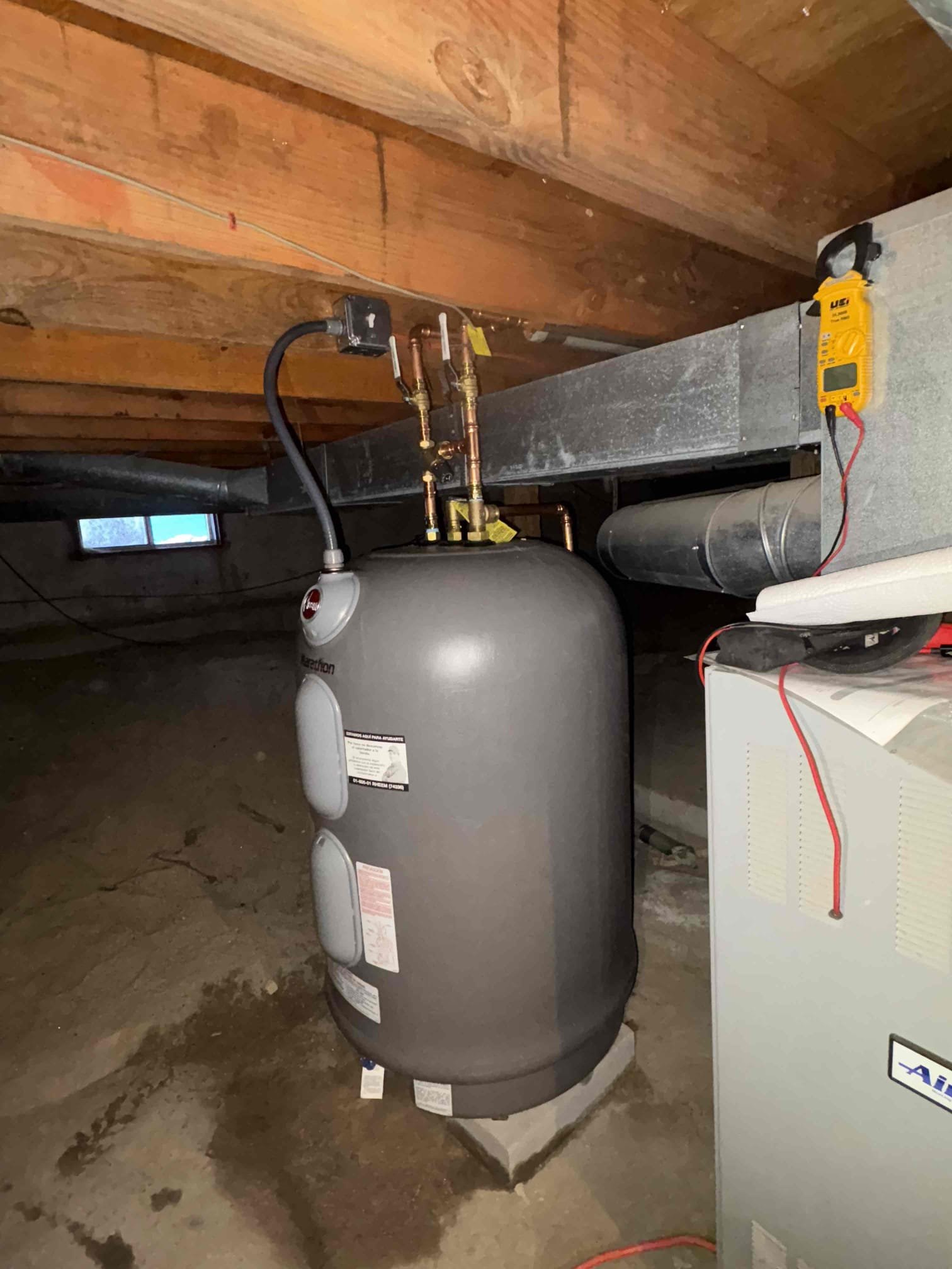The new 50-gallon Rheem Marathon electric water heater was installed and placed into service, with both thermostats set to 140 degrees and a mixing valve adjusted to provide 120-degree water at the home’s fixtures. A new electrical disconnect was added at the unit, and the hot and cold lines were repiped with individual shut-off valves and properly supported with hangers. After installation, the system was filled, powered, and tested to verify correct operation and confirm that no leaks were present.