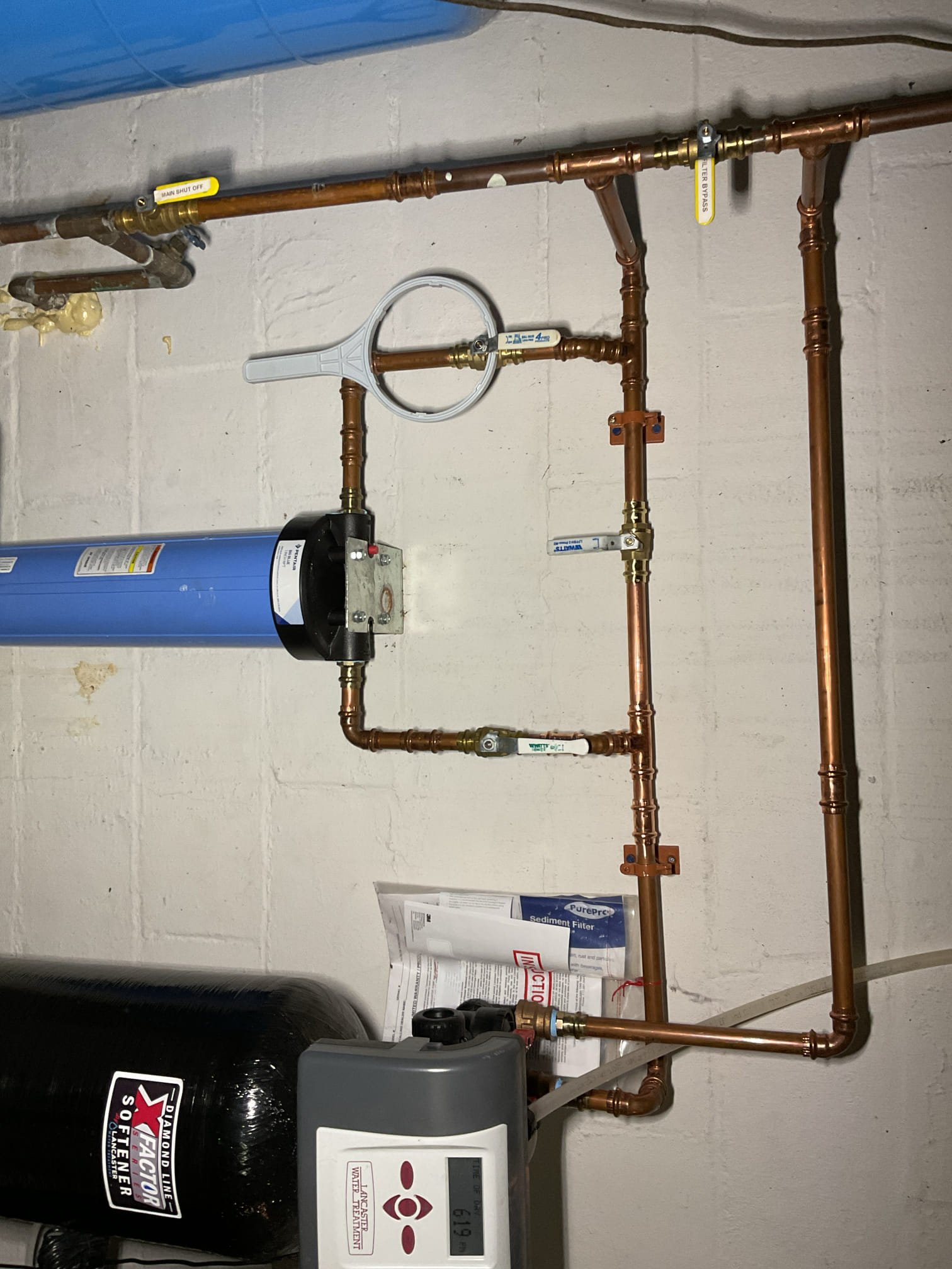 We found that the existing sediment filter required replacement to maintain proper water quality and flow. We recommended installing the customer-supplied filter to improve system performance and ensure reliable protection for the home’s plumbing. We also identified multiple sections of piping and fittings that were heavily corroded and beginning to leak, and advised replacing these components to stop the leaks and restore a dependable, long-lasting plumbing system.

Water to the system was shut off and fully drained. The existing sediment filter was removed, and we found it to be extremely dirty and packed with sediment, likely due to the well running low. The filter housing, including the threads and O-ring, was thoroughly cleaned. The new customer-supplied 4.5” x 20” sediment filter was installed hand tight, with lubricant applied to all gaskets and threaded connections.

We cut out and removed the corroded piping within the three-valve bypass for the filter housing, including one b