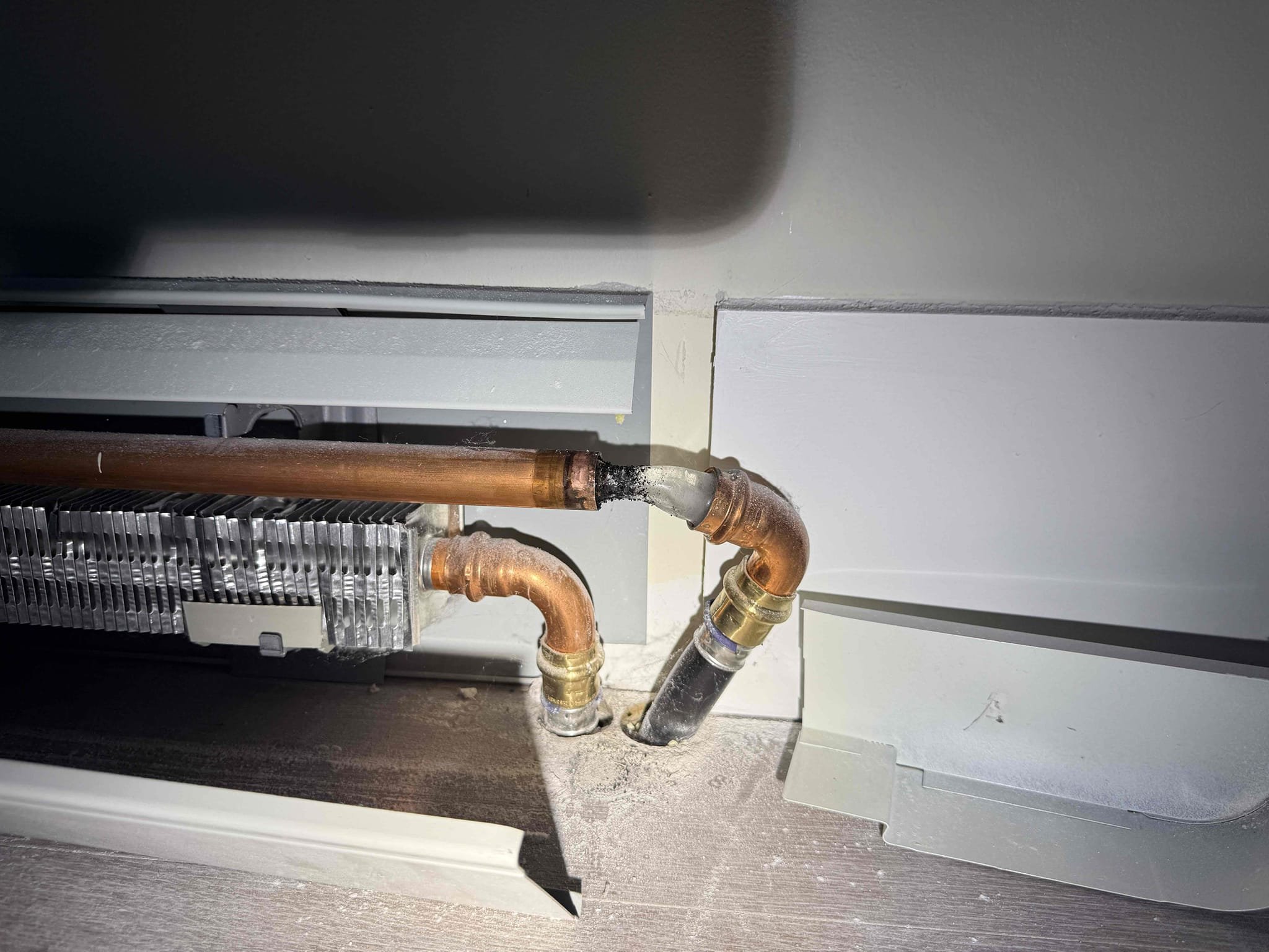 
Customer reported multiple burst pipes throughout the home. A walkthrough of the property revealed several breaks in the baseboard heating piping across multiple sections, as well as a frozen kitchen faucet. Numerous areas of baseboard piping are frozen and damaged to the extent that replacement is recommended rather than repair.

The customer was advised to place electric heaters near the boiler to prevent further freezing and potential damage to the boiler itself. The customer was also instructed to shut off the water supply to the system to prevent additional leakage. We went down to basement and shut the breaker off going to the well pump.

At this time, the customer plans to obtain portable heaters and gradually begin warming the home to minimize further damage. I will be discussing this situation with management to determine next steps and scheduling availability for repairs.