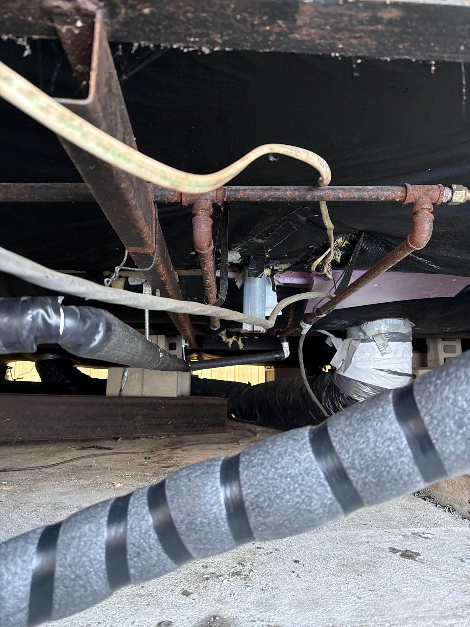 
Installed a new high-efficiency Thermal Pride furnace and removed and properly disposed of the existing unit. Connected the furnace using the existing electrical and thermostat wiring. Installed a new concentric vent through the existing roof jack. Installed a new gas valve and sediment trap. Ran condensate piping beneath the trailer, terminating at the exterior side; piping was insulated and secured with appropriate hangers. Informed the homeowner of the potential risk of condensate line freezing due to exterior routing.

Converted the furnace burners to LP using the appropriate orifices from the conversion kit and adjusted gas pressures to the manufacturer’s specified requirements. Tested furnace operation and verified proper functionality at this time.

During installation, it was discovered that the blower motor was damaged from the factory. Although the unit remains operational, a return visit will be required to replace the blower motor at a later date.