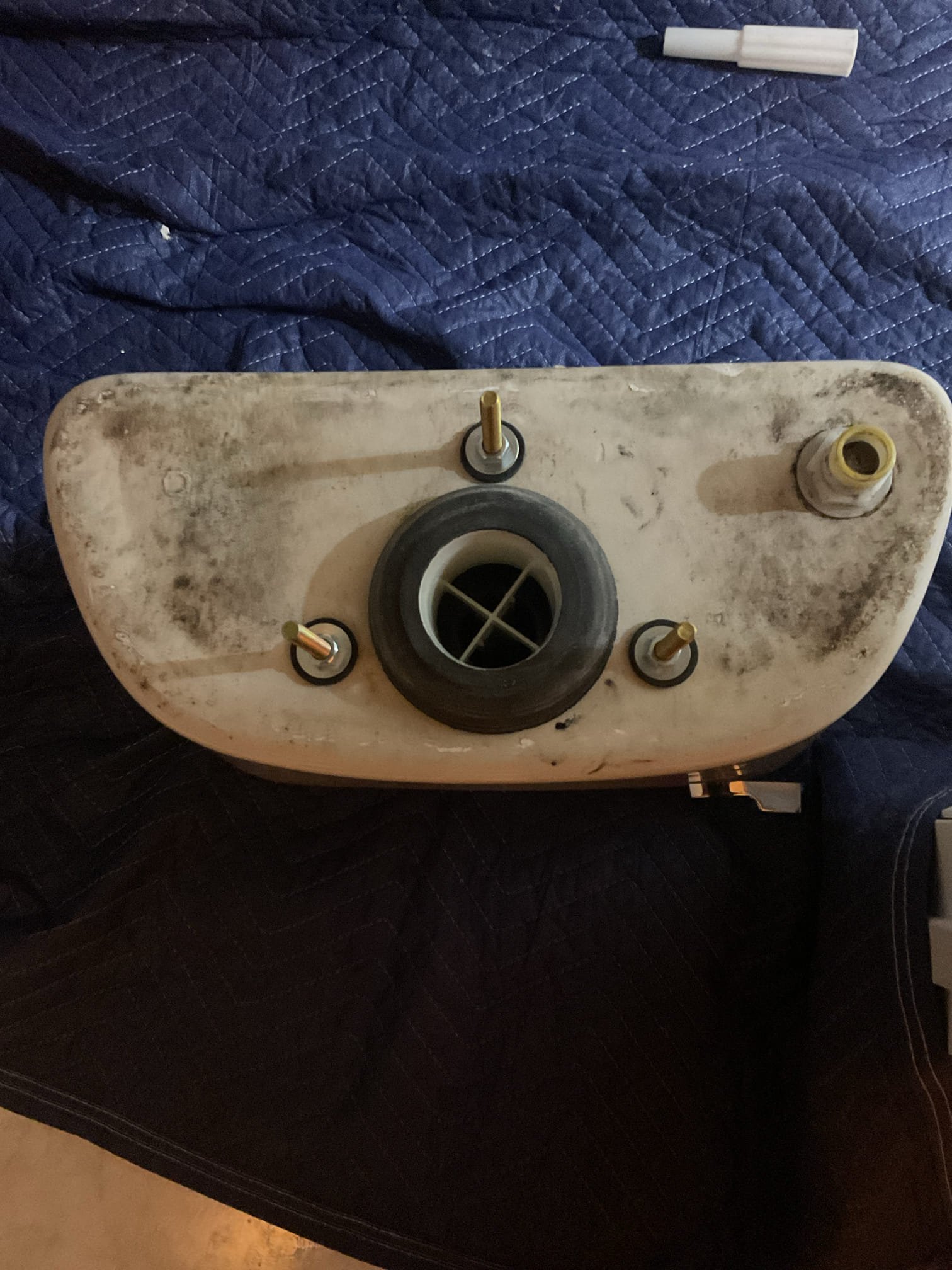 Upon inspection, the toilet was found to be rocking at the base and leaking from that location, indicating a failed seal and improper mounting. We recommended pulling and resetting the toilet with a new seal and proper anchoring to stop the leak, restore stability, and prevent potential water damage. The water supply was already shut off; remaining water was vacuumed, the supply line and closet bolts were disconnected, and the toilet was removed for inspection.

After removal, the toilet flange was found to be rusted and set well below the finished floor, preventing the wax seal from properly compressing during the homeowner’s prior repair attempt. Due to the deteriorated condition of the metal flange, the toilet could not be securely fastened or sealed. We recommended replacing the metal flange and raising it to floor level to ensure a proper, leak-free installation. The damaged flange was removed, a new repair flange was installed and secured to the floor, and plastic spacers were ad