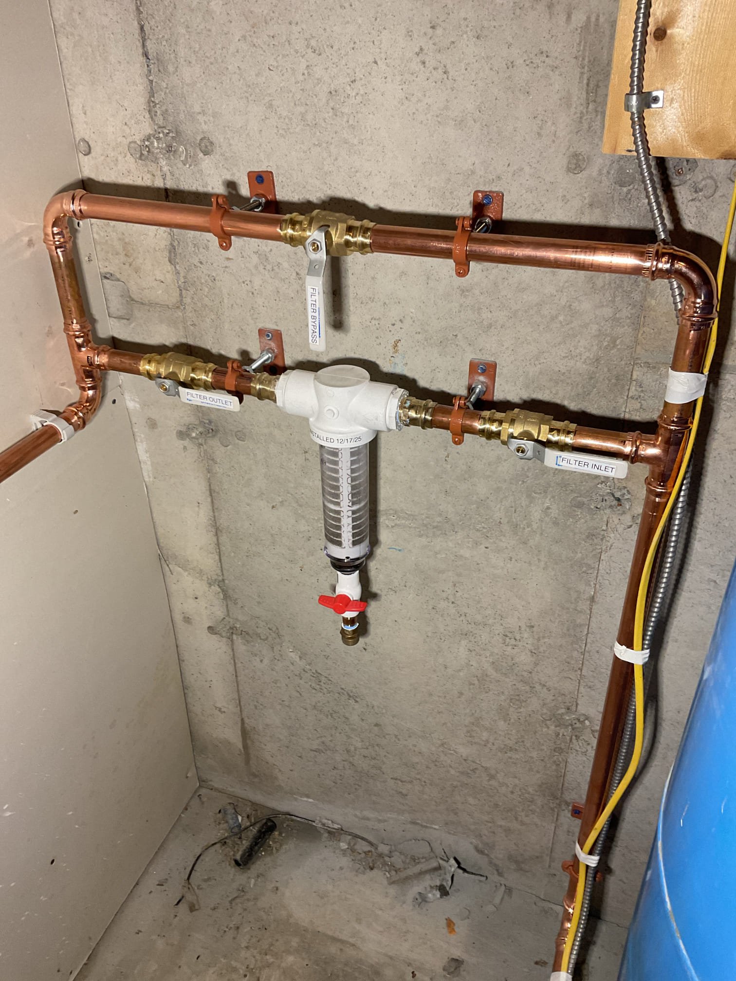 The home lacked adequate protection against sediment and debris entering the water system, which can negatively impact water quality and damage plumbing fixtures and equipment. We recommended and installed a new spin-down sediment filter to improve water quality and provide long-term system protection. To allow for proper installation, the water system was shut down and fully drained, and the pressure tank was relocated approximately 3 feet to the right due to limited clearance at the original location. The pressure tank was reconnected to the incoming well water supply and securely mounted to the wall. New piping was installed from the pressure tank up the wall into a three-valve bypass for the filter, then reconnected to the existing main water supply serving the home. All piping was properly supported with new hangers, leveled, and secured. A hose adapter was installed at the bottom of the spin-down filter to allow for easy cleaning and maintenance.

We also found the pressure switc