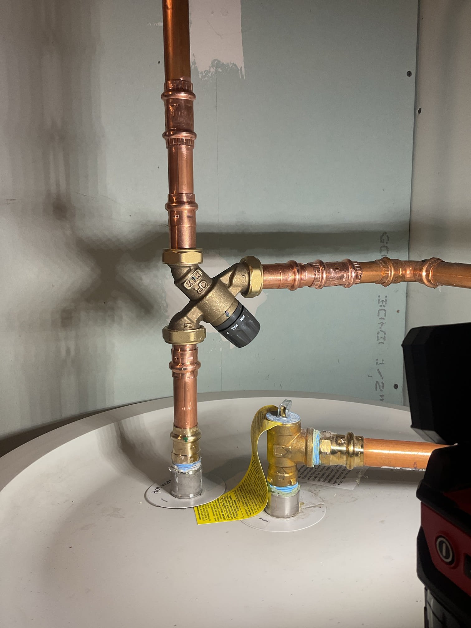 The existing tub/shower valve was leaking and failing to deliver consistent hot water, and due to prior unsuccessful repair attempts, full replacement was recommended to restore proper operation. Water was shut off and the system drained, the existing valve and trim were removed, and a new valve was installed on added blocking with new connections for hot, cold, and shower piping; new trim, tub spout, shower arm, and customer-supplied handheld sprayer were installed, the system was tested with no leaks or issues found, and all trim was sealed with caulking for added waterproofing.

The existing mixing valve was leaking and had severely corroded fittings, so replacement was recommended to ensure safe and reliable performance. Water was shut off and the system drained, the failed valve and fittings were removed, and a new mixing valve was installed with new copper piping and adapters; the system was restored and tested with no leaks present at this time. The customer was also enrolled in