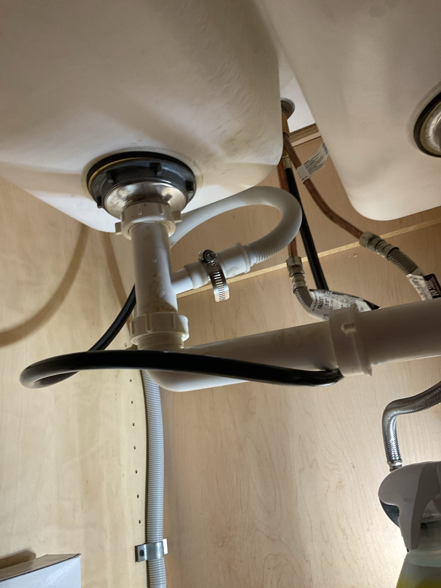 The kitchen faucet side sprayer hose was torn and leaking, causing improper operation. We replaced the sprayer hose and spray head, cleaned the sink base, installed a new escutcheon, and tested the fixture after restoring water, confirming proper operation with no leaks present at this time.