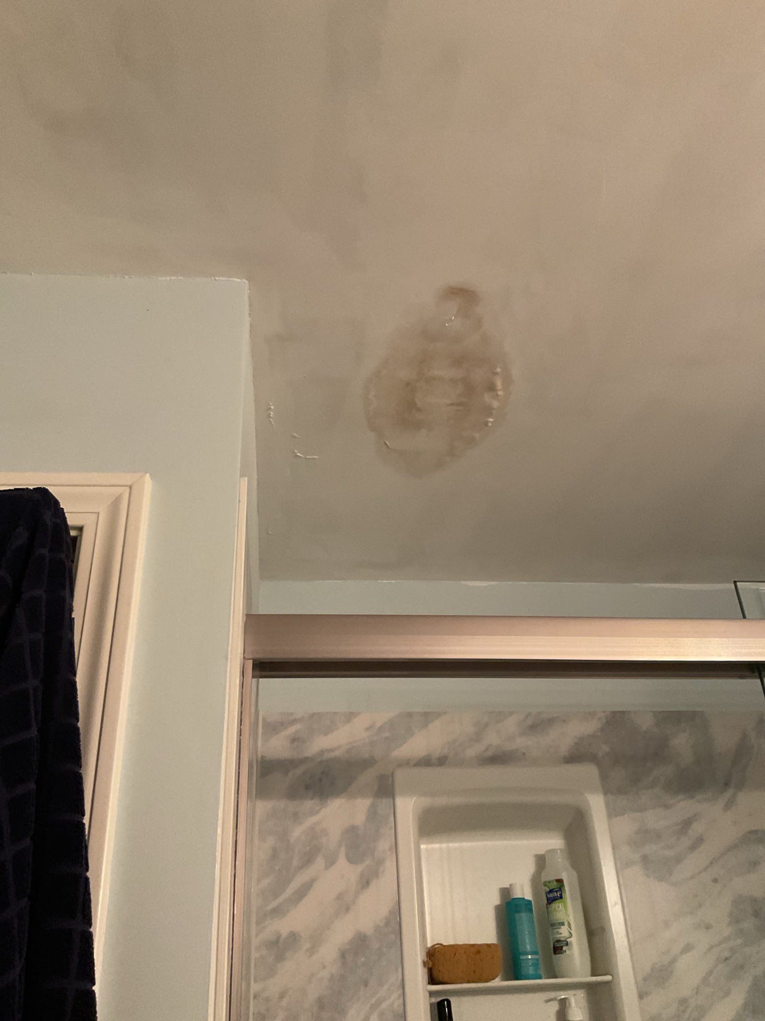 For this service call, the homeowner reported a suspected leak originating from the attic. Upon arrival, two areas of water damage were confirmed in the ceiling of the primary bathroom. Inspection of the attic revealed leaks at two bathroom exhaust fan discharge lines; this condition had occurred previously and was only temporarily resolved at that time. The half-bath exhaust connection showed ice buildup at the transition from the plastic discharge line to galvanized piping, and the primary bathroom fan was leaking at the plastic connection to the unit, with sagging piping that allowed condensation to collect.

After discussing findings with the homeowner, it was determined that the likely cause is reduced fan performance combined with uninsulated exhaust piping, allowing moisture to cool and condense before exiting the home. An estimate will be provided to replace both exhaust fans and to replace sections of the discharge lines with new, insulated metal piping to help prevent future 