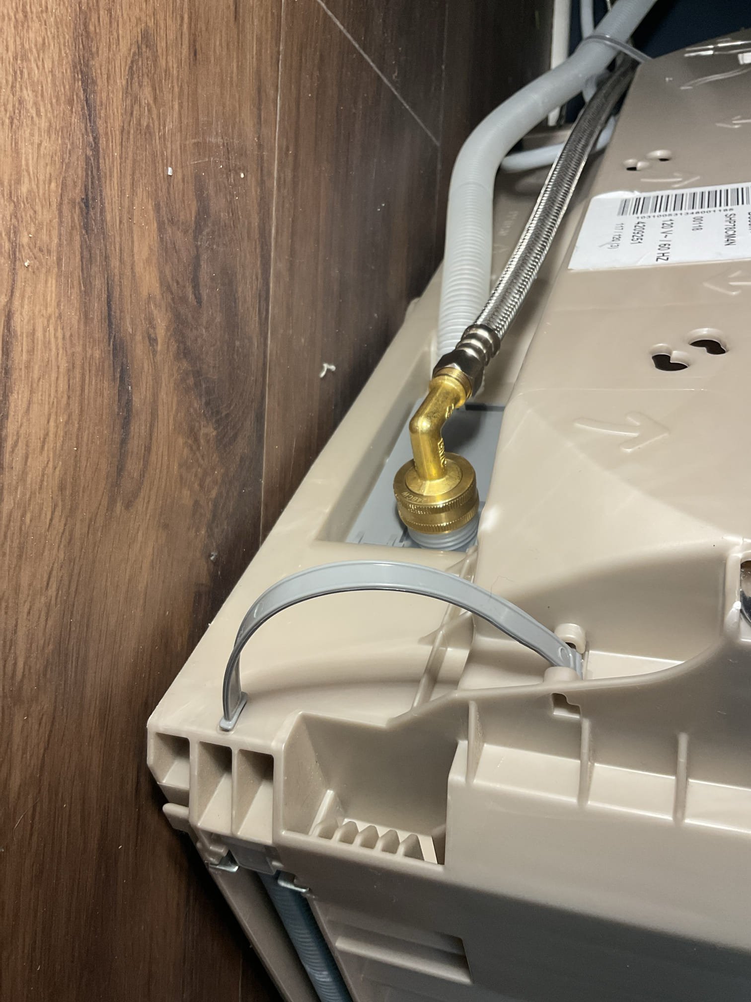 For this service call, the homeowner reported a constant leak from beneath the dishwasher and shut off the water supply to the unit. The dishwasher, which was recently installed by our company and is under warranty, was removed from the cabinet for inspection. The leak was traced to a slow drip at the supply hose connection to the unit. The connection was tightened and the dishwasher was tested for approximately 15 minutes with no leaks observed, confirming the issue was resolved. The unit was then reinstalled and secured in the cabinet.