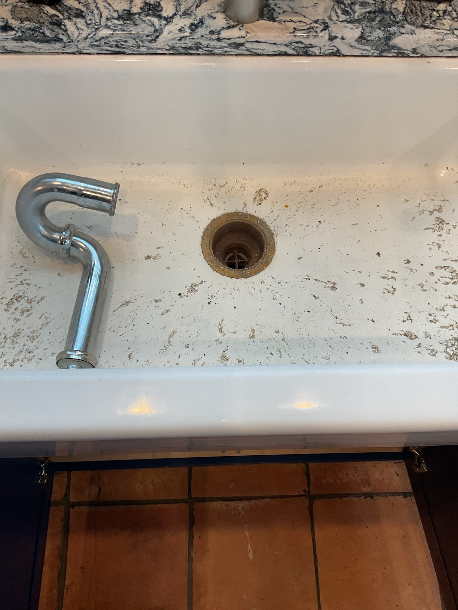 An attempt was made to clear a blockage in the kitchen sink drain. The drain line was snaked from the kitchen sink down to the 3-inch main drain, where a blockage was encountered that could not be cleared from the upstairs access point. A rubber Fernco coupling was then removed to gain additional access to the line, allowing the drain to be snaked from that location. The blockage was successfully cleared, and the kitchen sink was tested and is now draining properly. All components were reinstalled and secured, and the drain system is functioning as it should.