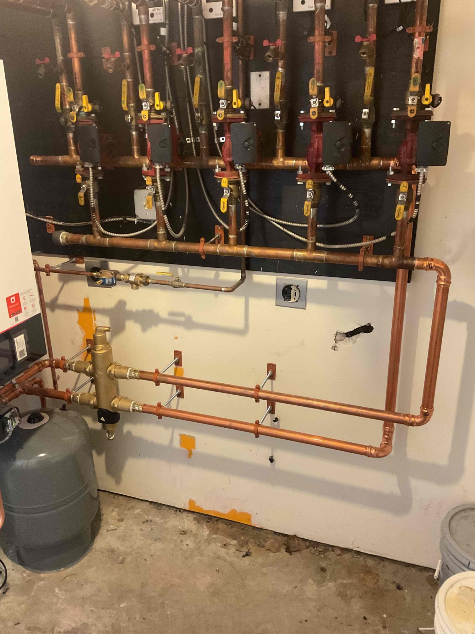 
Installed new Viessmann 200 Series boilers in each building, including complete removal and replacement of associated systems. Scope of work included installation of new venting and condensate piping, required electrical connections, near-boiler piping, and the addition of new high-limit and low-water safety controls. Each propane system was pressure tested with a three-minute leak check to confirm leak-free operation. All heating zones were individually purged and balanced, with twelve zones per building addressed to ensure proper circulation. Boiler operating curves were programmed for maximum efficiency while maintaining consistent heat output and occupant comfort. Final startup procedures were completed, and all systems were tested and verified for proper and safe operation.