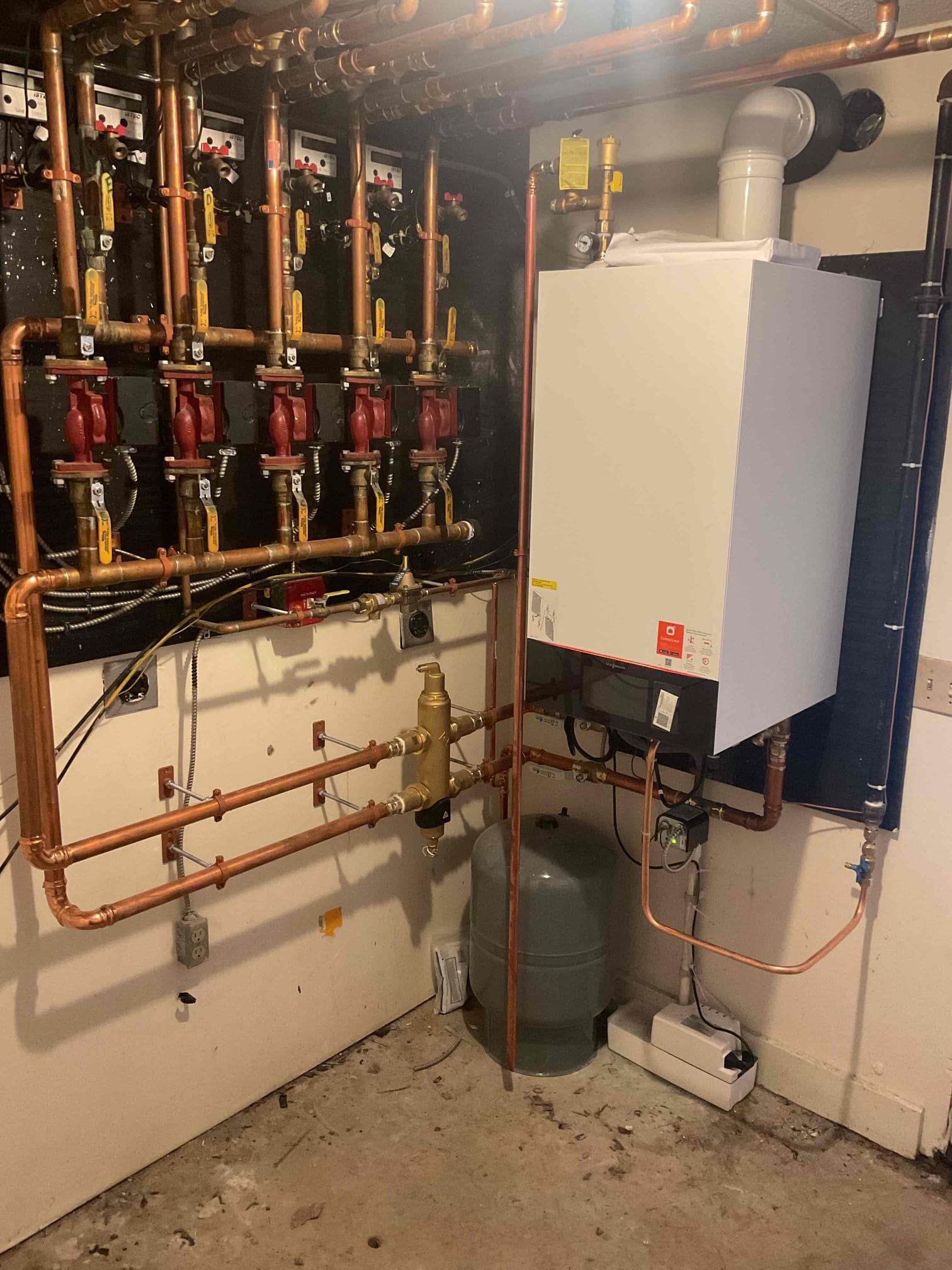 
Installed new Viessmann 200 Series boilers in each building, including complete removal and replacement of associated systems. Scope of work included installation of new venting and condensate piping, required electrical connections, near-boiler piping, and the addition of new high-limit and low-water safety controls. Each propane system was pressure tested with a three-minute leak check to confirm leak-free operation. All heating zones were individually purged and balanced, with twelve zones per building addressed to ensure proper circulation. Boiler operating curves were programmed for maximum efficiency while maintaining consistent heat output and occupant comfort. Final startup procedures were completed, and all systems were tested and verified for proper and safe operation.