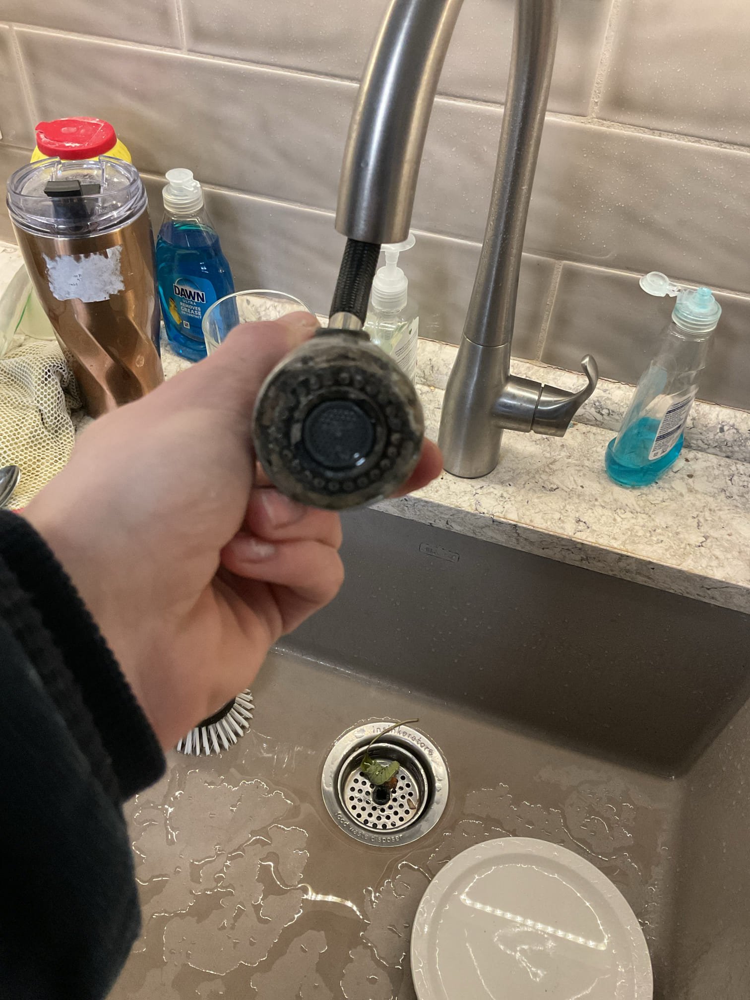 The spray head on the Kohler faucet was replaced after diagnosing a noticeable loss of water pressure when the spray head was installed compared to when it was removed. Upon inspection, the existing spray head was found to be internally restricted and no longer functioning properly, which was limiting water flow. The old spray head was removed and a new, compatible Kohler spray head was installed and securely connected. The faucet was then tested in both standard flow and spray modes to confirm proper operation and restored water pressure. At completion, the faucet was operating as designed with consistent pressure and no leaks observed. Customer would like a hard copy of receipt sent to her as well as email.