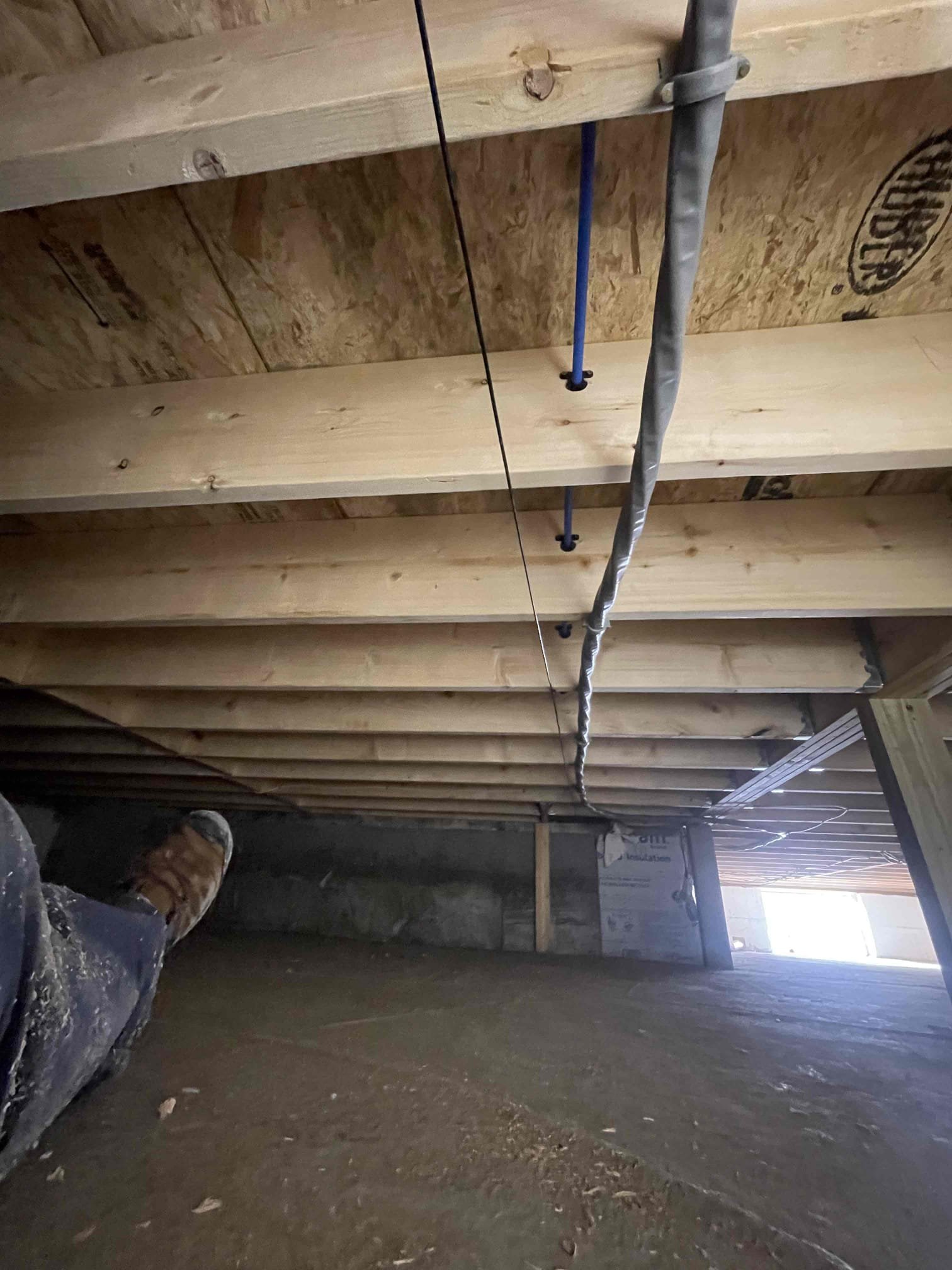 The homeowner requested relocation of the existing laundry connections from the basement to a newly constructed addition connecting the garage to the home. We proposed and completed a full laundry rough-in to provide reliable water supply, drainage, and venting, making the space fully functional and ready for appliance installation. This estimate does not include installation of the dryer vent.

Scope of Work Completed:
	•	Installed a recessed washer outlet box with a single-handle, dual-port washer valve and integrated drain receptacle on the interior wall separating the mudroom and laundry room.
	•	Installed PVC piping for the drain, waste, and vent (DWV) system and PEX piping for the water supply system throughout the crawl space.
	•	Connected a 2” PVC drain line from the washer box into the crawl space, properly supported within the floor joists and routed through the existing foundation wall near the current dryer vent termination.
	•	Installed the 2” drain vertically in the far-l