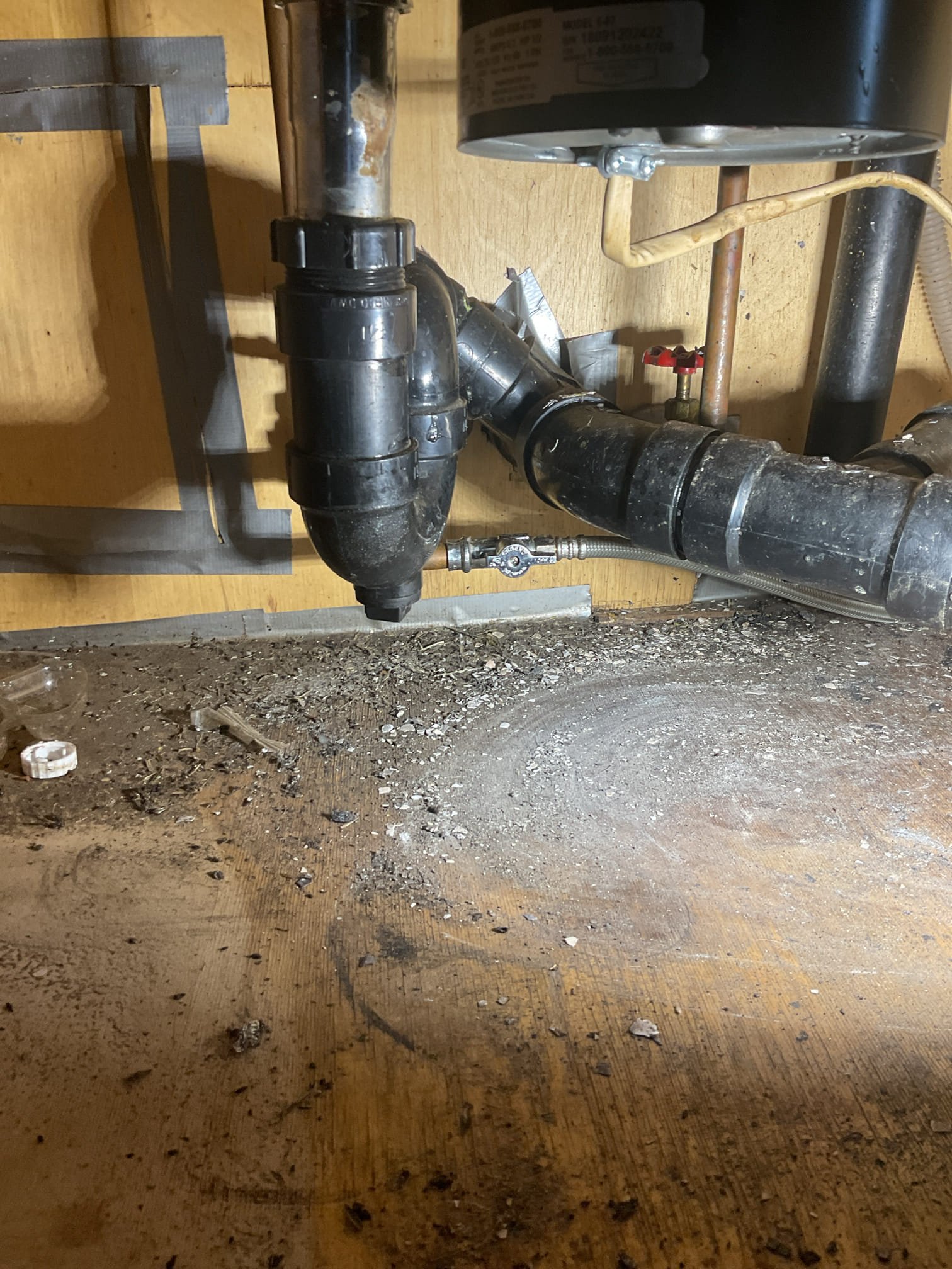 The kitchen drain line was partially blocked, resulting in slow and restricted drainage. We attempted to clear the line using an electric snake, accessing the system through the end cleanout and running the snake approximately 25 feet with multiple passes to remove food and grease buildup that was causing several partial obstructions. Standing water was drained, the cleanout plug was reinstalled, and the line was flushed with warm water. A drain cleaner (Thrift) was added to help break down any remaining buildup. The sink was tested multiple times by filling and draining the basin, confirming proper operation with no leaks present at this time.