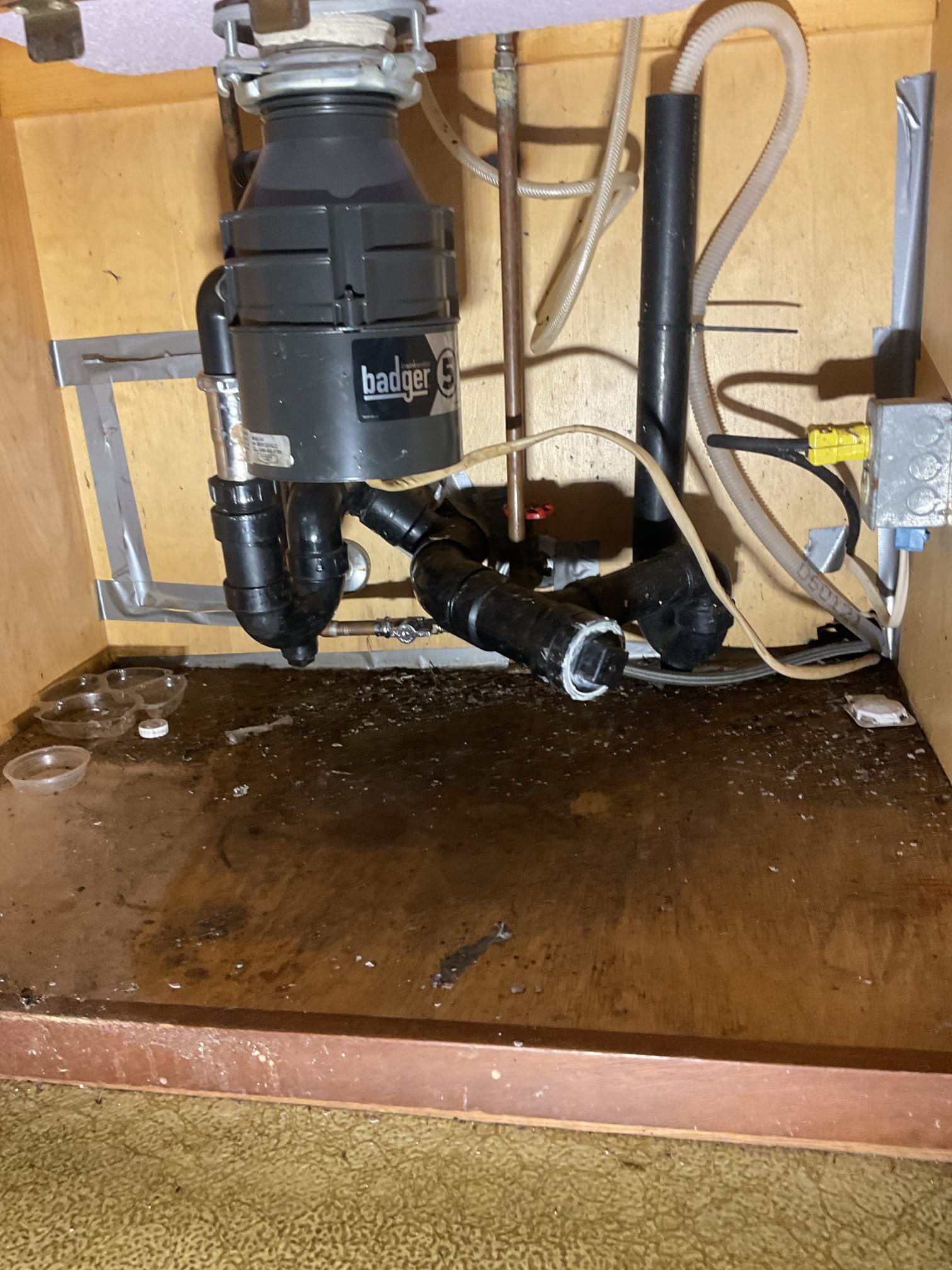 The kitchen drain line was partially blocked, resulting in slow and restricted drainage. We attempted to clear the line using an electric snake, accessing the system through the end cleanout and running the snake approximately 25 feet with multiple passes to remove food and grease buildup that was causing several partial obstructions. Standing water was drained, the cleanout plug was reinstalled, and the line was flushed with warm water. A drain cleaner (Thrift) was added to help break down any remaining buildup. The sink was tested multiple times by filling and draining the basin, confirming proper operation with no leaks present at this time.