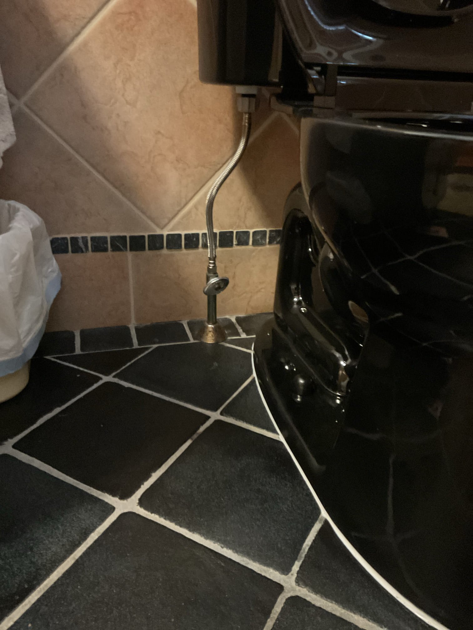 The homeowner requested replacement of the upstairs bathroom toilet, and we recommended installing a black Kohler Highline model to match the master bathroom for a consistent appearance and improved reliability. Water was shut off and the existing toilet was fully drained, disconnected, removed, and properly disposed of.

Upon removal, the toilet flange was inspected and found to be severely corroded with compromised structural integrity. A new flange was installed to provide a secure and stable mounting surface and prevent future movement. During installation, it was discovered that the existing PVC flange was not properly secured to the drainage piping; the flange was correctly glued and fastened using screws to ensure a solid connection. The new toilet was installed using new closet bolts, wax ring, and braided supply line, and shims were used to level the base. Water was restored and the system was tested for proper operation with no leaks present at this time. A bead of clear caul