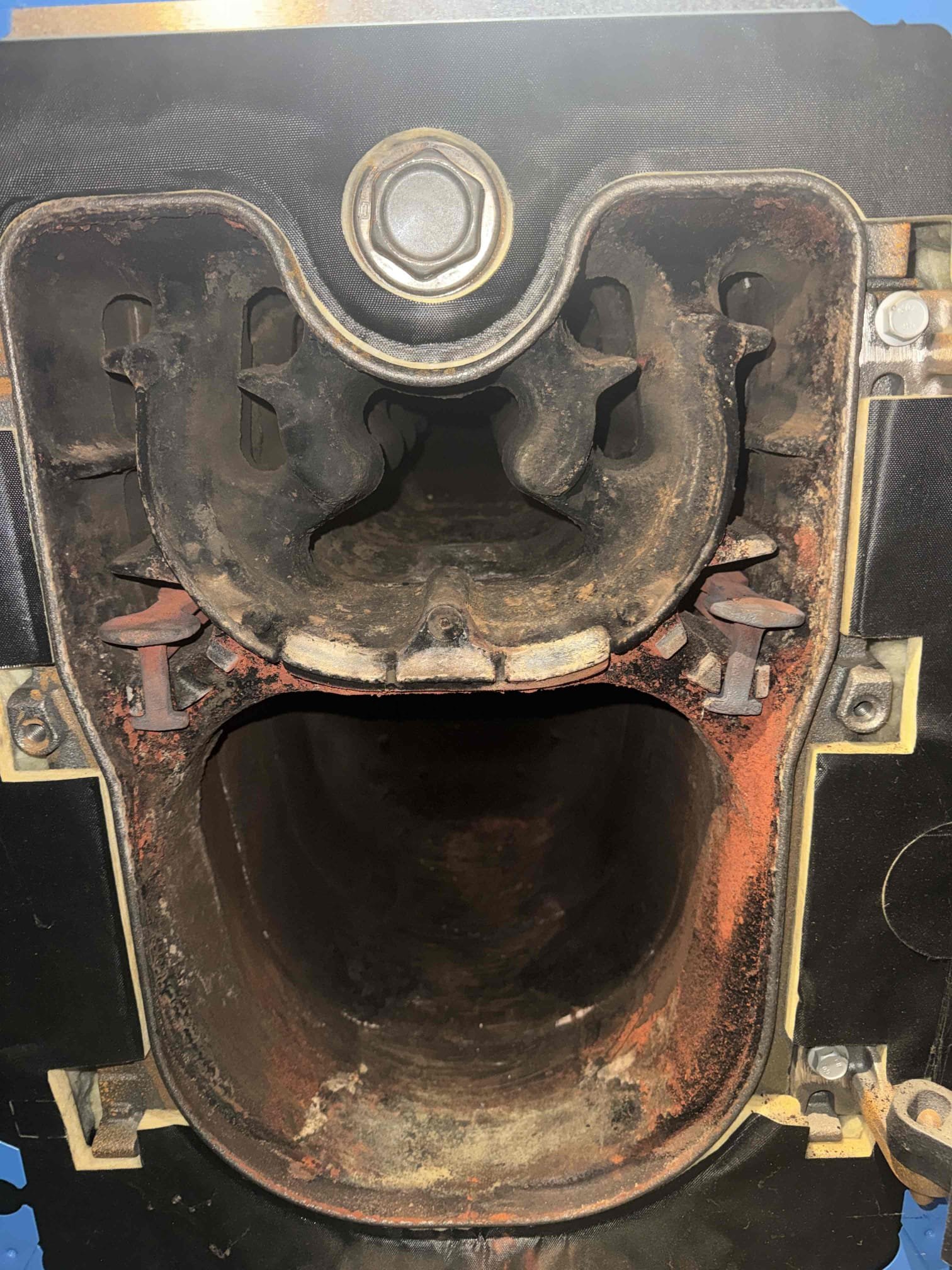 The customer reported having to repeatedly reset the Logamatic boiler control. Upon arrival, the boiler was started and found to be running very rough, indicating the need for a full service. The oil nozzle, oil filter, and oil strainer were serviced, with the strainer found to be heavily contaminated. The oil line was pressure/vacuum tested and exhibited very weak flow; the burner end cone was also heavily sooted, restricting proper airflow.

The boiler was opened and found to be severely plugged with soot, including the heat exchanger, smoke pipe, and chimney connection. All components were thoroughly brushed and vacuumed to restore proper draft and combustion.

A diagnostic evaluation of the Logamatic control was then performed to determine the cause of repeated fuse failures. Evidence of rodent activity was found inside the control, including contamination of the circuit boards. Due to the extent of the damage, and with customer approval, the Logamatic control was removed and repla