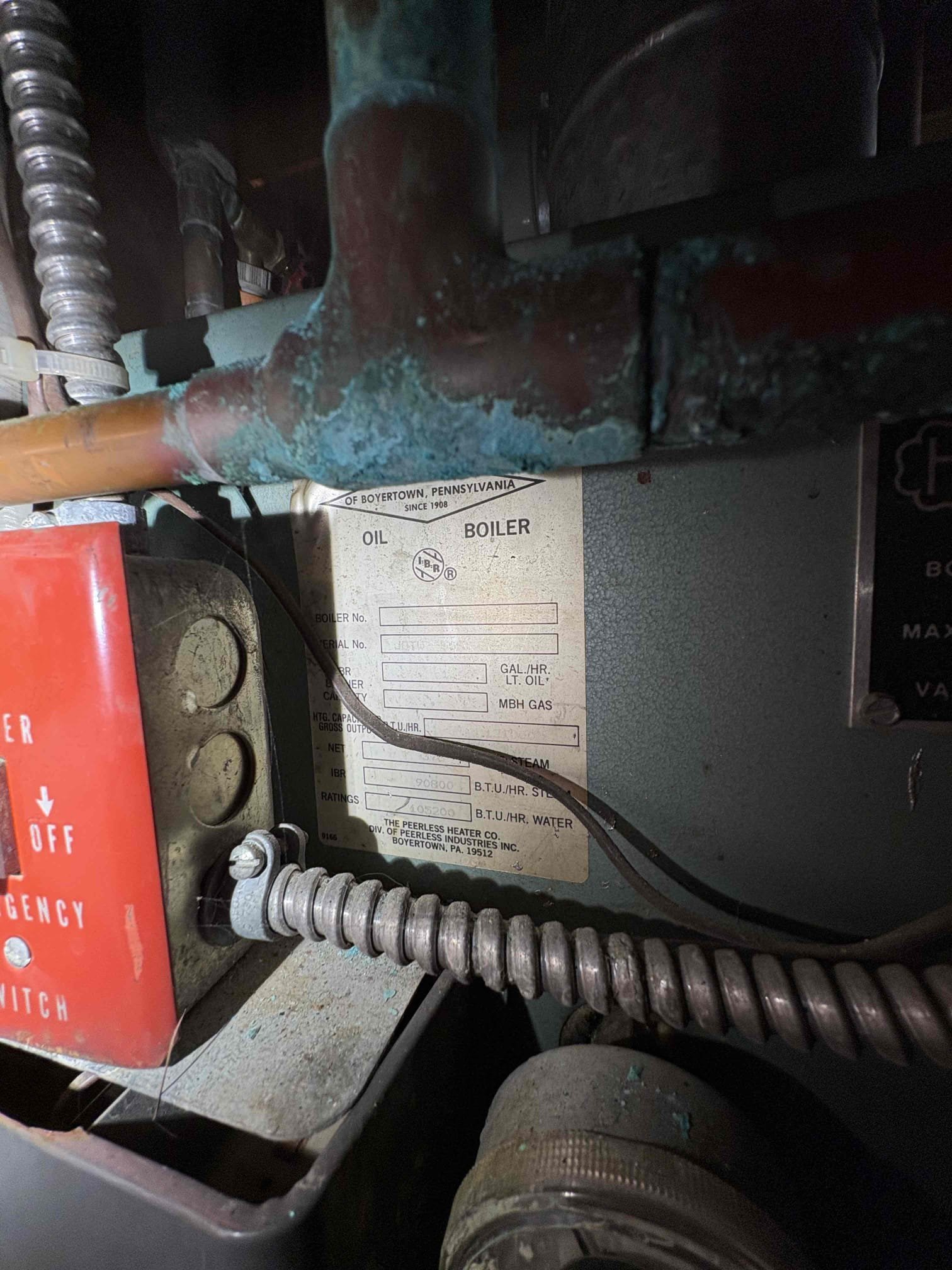 Performed annual maintenance on a Peerless oil boiler. Upon arrival, multiple failed and deteriorated components were identified, including a failed expansion tank, failed Hy-Vents, a suspected failed mixing valve, and several heavily corroded fittings and valves. After removing the boiler jacket panels, significant soot accumulation was found on the insulation and between the boiler sections. A specific source of flue gas leakage could not be identified.

The system was installed in 1989 and exhibits extensive signs of age and deterioration. Due to the poor condition of the existing valves and drains, hydronic repairs or component replacements cannot be performed reliably at this time. Based on the overall condition of the system, full boiler replacement is strongly recommended as soon as possible. While the boiler appears to be operating safely at present, the amount of required updates combined with soot accumulation inside the jacket make replacement the only practical long-term op