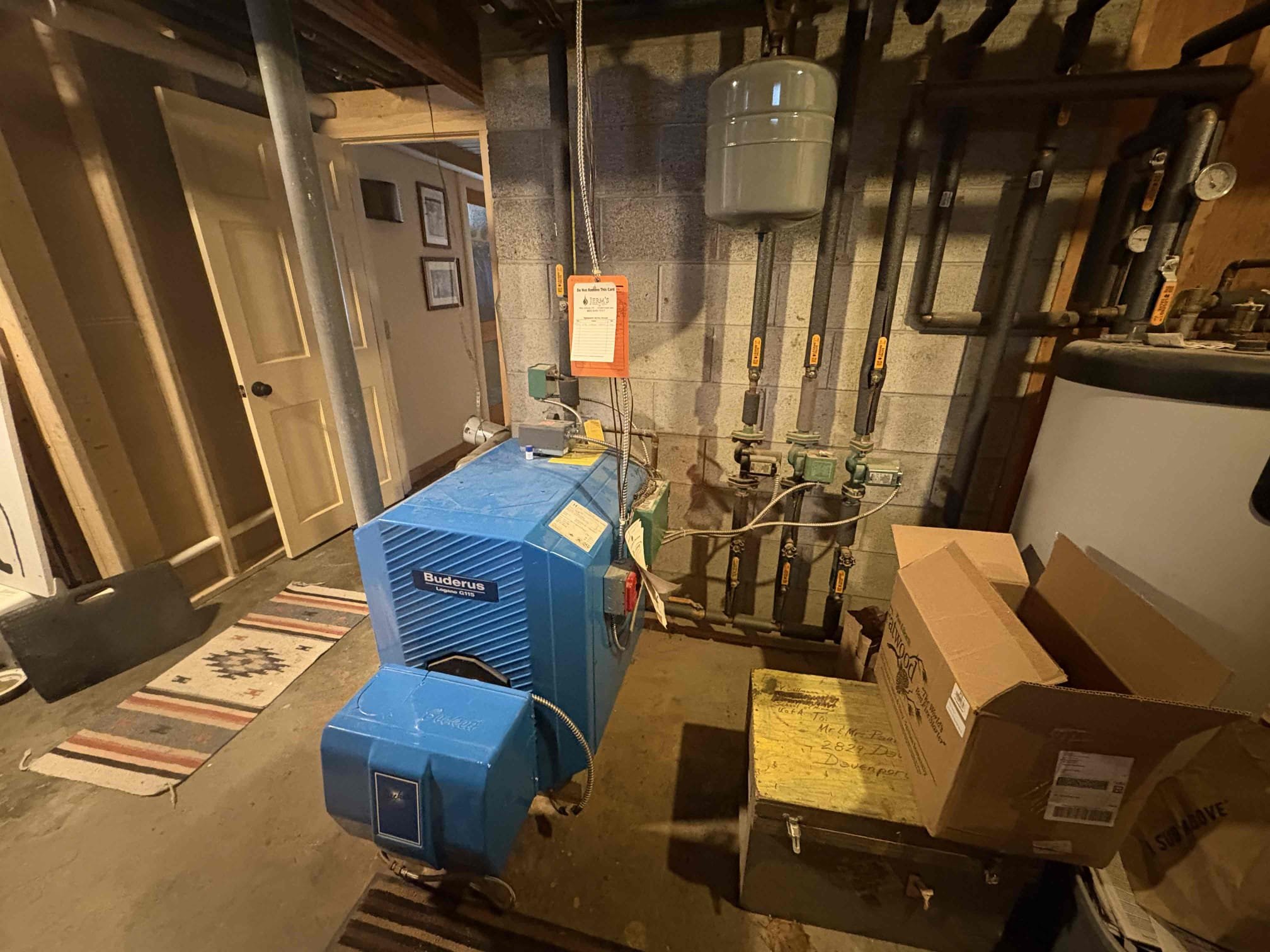 Performed annual maintenance on Buderus oil-fired boiler. Replaced burner nozzle, oil filter, and strainer. Cleaned heat exchanger and flue pipe by brushing and vacuuming. Tested and verified proper operation of all burner components, safety controls, and hydronic system components. Performed combustion analysis, smoke test, and draft test. Resealed flue pipe connection at the chimney using furnace cement. System is operating properly at this time.

During inspection, a heavily corroded Hy-Vent air elimination device was observed on the indirect water heater. The ST-5 expansion tank serving the indirect water heater was found to have failed and is waterlogged. Authorization to perform these repairs was not provided at the time of service. Estimates for replacement of these items will be provided separately.
