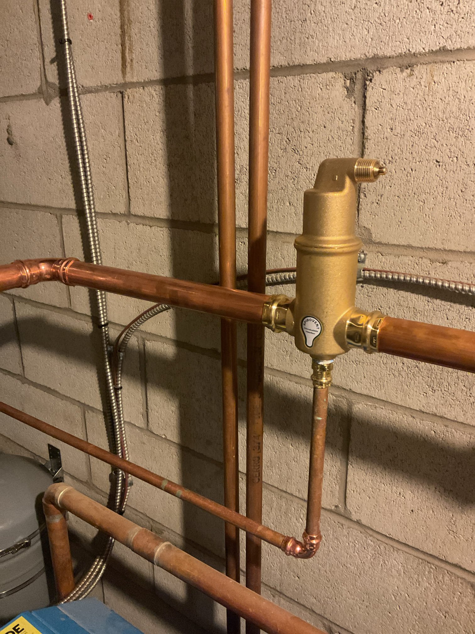 The boiler supply was re-piped to include a main air elimination device, and the failed expansion tank was relocated to the wall adjacent to the boiler. This work was completed to address the air entrapment occurring in the water heater zone and to reduce air-related issues throughout the system. Upon completion, all heating zones were verified to be circulating properly, and the system was purged to ensure all air was removed. 