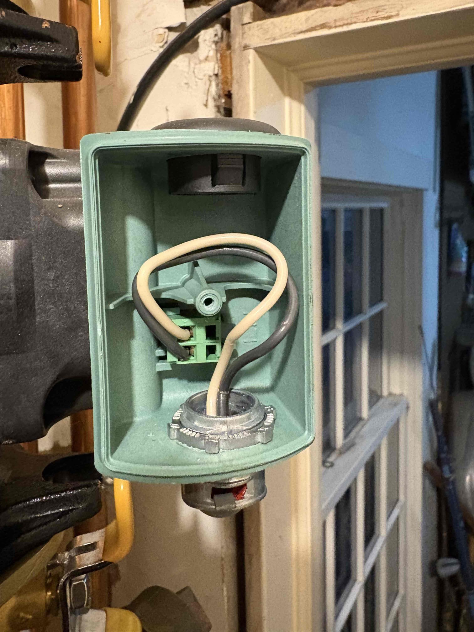 Responded to a no-heat complaint in the garage and the space above the garage. Upon arrival, confirmed a call for heat from the thermostat and observed that the return piping for zone 1 was cold. Purged the zone and verified there were no freeze conditions. Confirmed proper water circulation through the zone. Observed the circulator intermittently cycling on and off despite a constant call for heat. Verified proper voltage at the relay board and at the circulator. Determined that the electrical plug at the circulator was not fully secured. Reseated the connector and verified secure connections at all remaining circulators. The system is operating properly at this time.
