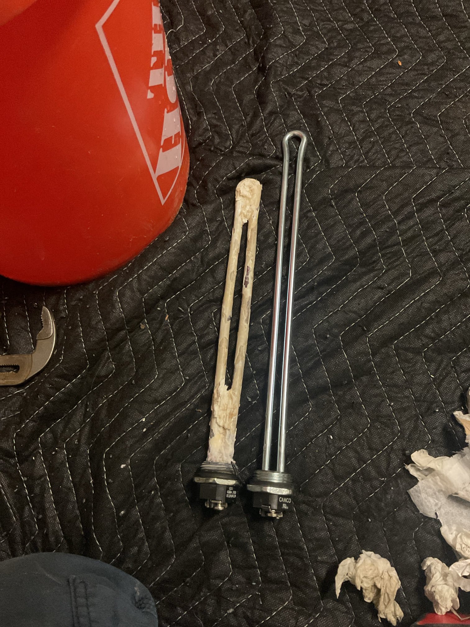 The homeowner reported a loss of hot water following a recent replacement of the lower heating element. Upon arrival, we found the safety reset on the upper thermostat had tripped, indicating a likely failure of the upper heating element and weakened thermostats. We recommended a full thermostat rebuild, including replacement of the remaining heating element and both thermostats, to restore efficient operation, improve performance, and extend the service life of the water heater.

Water was shut off and the tank was drained below the upper element to complete the repairs. The upper element was found to be heavily coated with calcium buildup, which likely contributed to the failure. Both upper and lower thermostats were replaced, the unit was refilled, air was purged from the system, and power was restored. Proper operation was confirmed with the upper element heating and warm water verified at the fixture prior to departure.