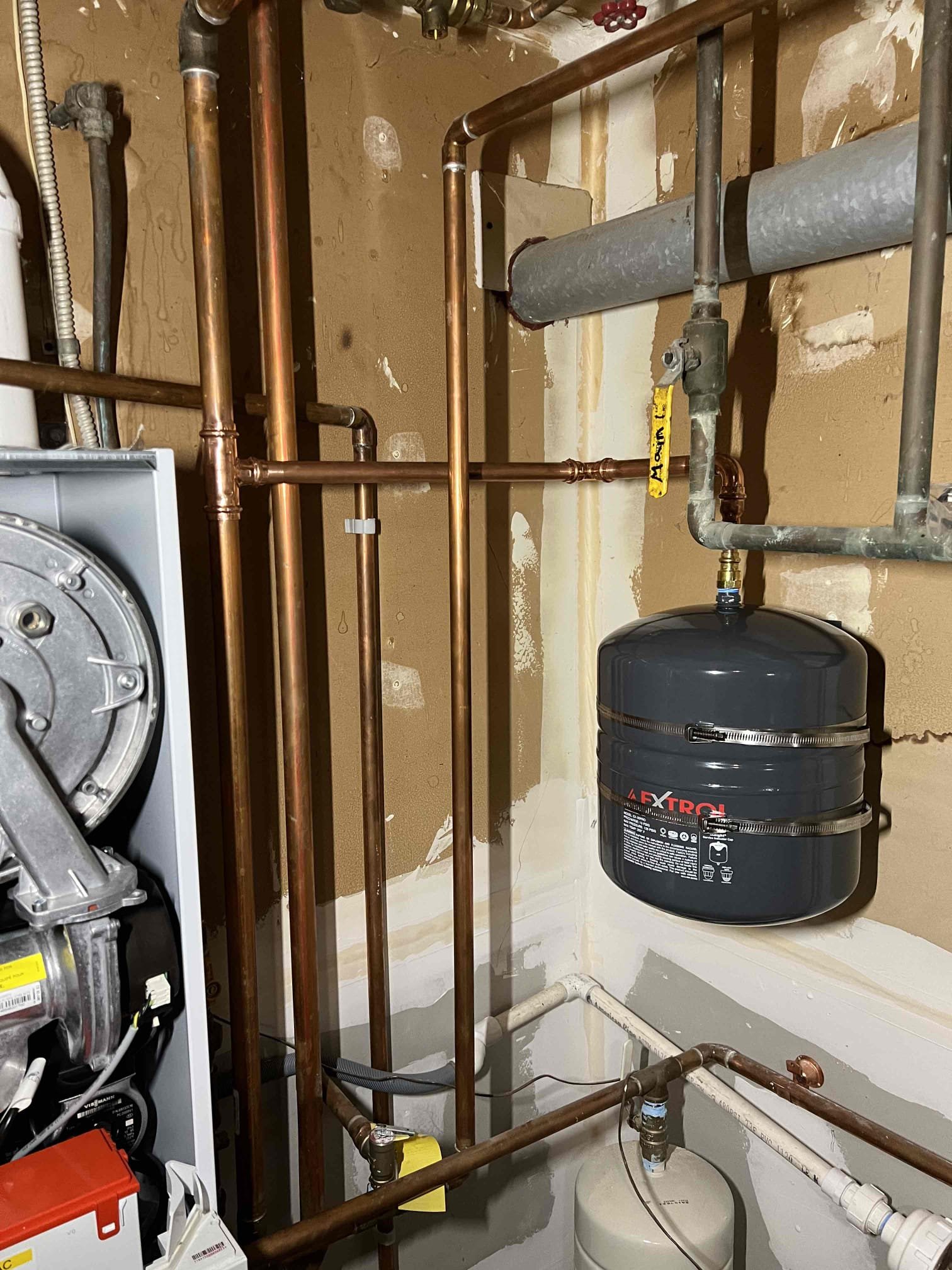 Arrived onsite to investigate a water leak on a Viessmann propane boiler. Determined the leak was coming from the relief valve. Upon inspection, the internal expansion tank was found to have failed, causing the relief valve to discharge. Installed an external expansion tank and replaced the relief valve. Purged air from the system and verified proper operation. The system is operating correctly at this time. Provided estimates to perform an annual tune-up and flush domestic hot water heat exchanger.