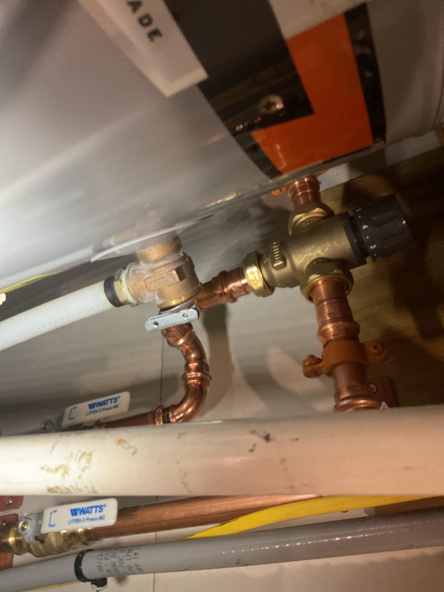 We found that the water system was not properly configured, with the pressure tank not serving as the starting point of the system and portions of the water heater piping not meeting current code requirements. We recommended redirecting the water lines to properly position the pressure tank and reworking the water heater piping to meet code, improving overall system reliability, efficiency, and safety.

The existing PEX piping to the pressure tank and water heater was cut out and removed. A new sediment filter housing with a three-valve bypass was mounted to the left of the mechanical space to allow filtration and easy isolation for maintenance. The filter housing was secured to the ship-lath siding, a boiler drain was installed on the outlet to relieve pressure during cartridge changes. The homeowner was instructed on proper cartridge replacement procedures.

New piping was installed from the existing poly water line below the residence up through the floor to the pressure tank inlet.