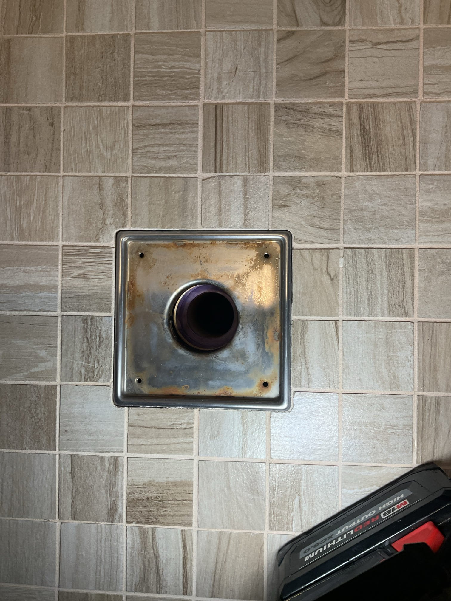 We identified signs of a possible leak beneath the shower; however, the source could not be confirmed without further access. After removing a section of Sheetrock below the shower for inspection, no active leaks were observed from the supply lines, valve body or drain, but water was noted leaking from the lower left corner of the shower wall when water was run along the tile, indicating failure at the tile or grout area. Additional cracking was observed along the shower base, and we recommend evaluation by a tile professional for further repair. The work area was cleaned and all debris was removed upon completion.