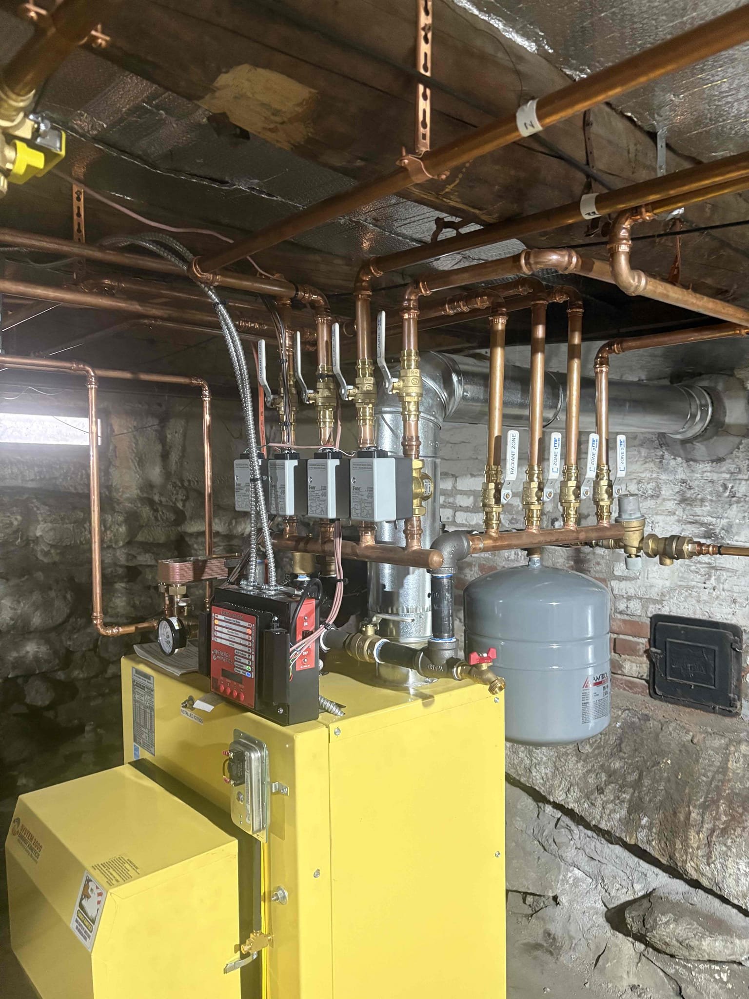 Disassembled and removed the old boiler from the basement. Cleaned the surrounding area and removed all associated components from the site. Jim reported hearing air in the first-floor piping. The first-floor zone was thoroughly purged, and an air pocket was identified and removed. Verified proper circulation with no remaining air noise in the piping. Confirmed proper operation of both upstairs and downstairs thermostats; each calls independently and responds as designed.

The system is operating properly at this time.