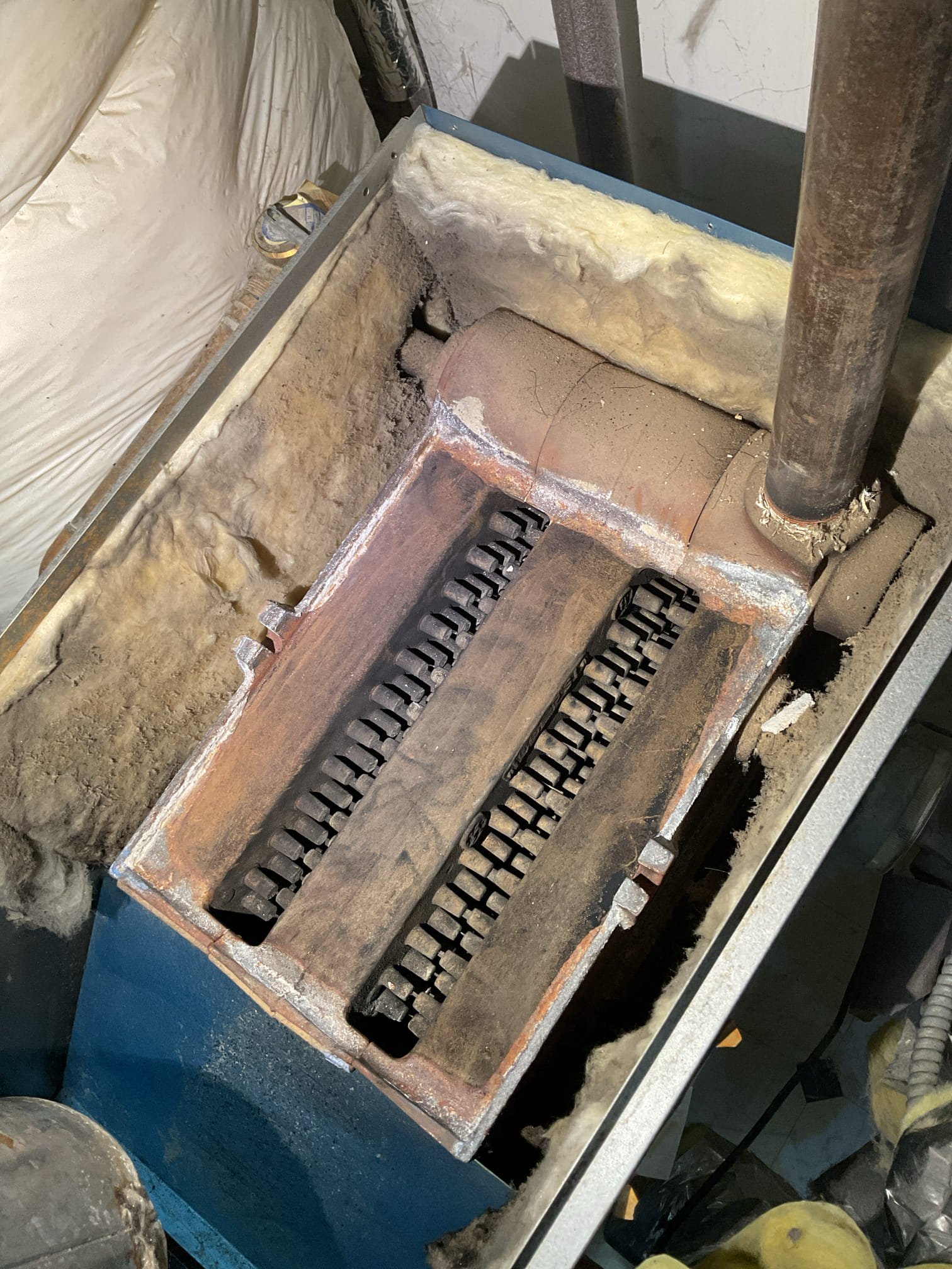 Arrived on site to figure out why boiler was making a popping noise and shooting out soot on startup. Upon arrival, we found that the boiler was actually rolling out on startup. We pulled the burners and pilot assembly. We removed the vent to clean the top of the heat exchanger. After cleaning it we tried ignition again. Same outcome, boiler flames rolled out the front. We found that the regulators outside were very old and past their lifespan. We adjusted the gas pressure to as close to 10” w.c. As possible. We believe the old regulators could be the cause of the flame rollout. As of right now, as long as the pilot does not go out, the flame rollout should not happen. We cycled the boiler 4-5 times using the thermostat and no rollout had occurred.  We determined it was safe to run for now but the propane company should come out and replace both outdoor regulators. 