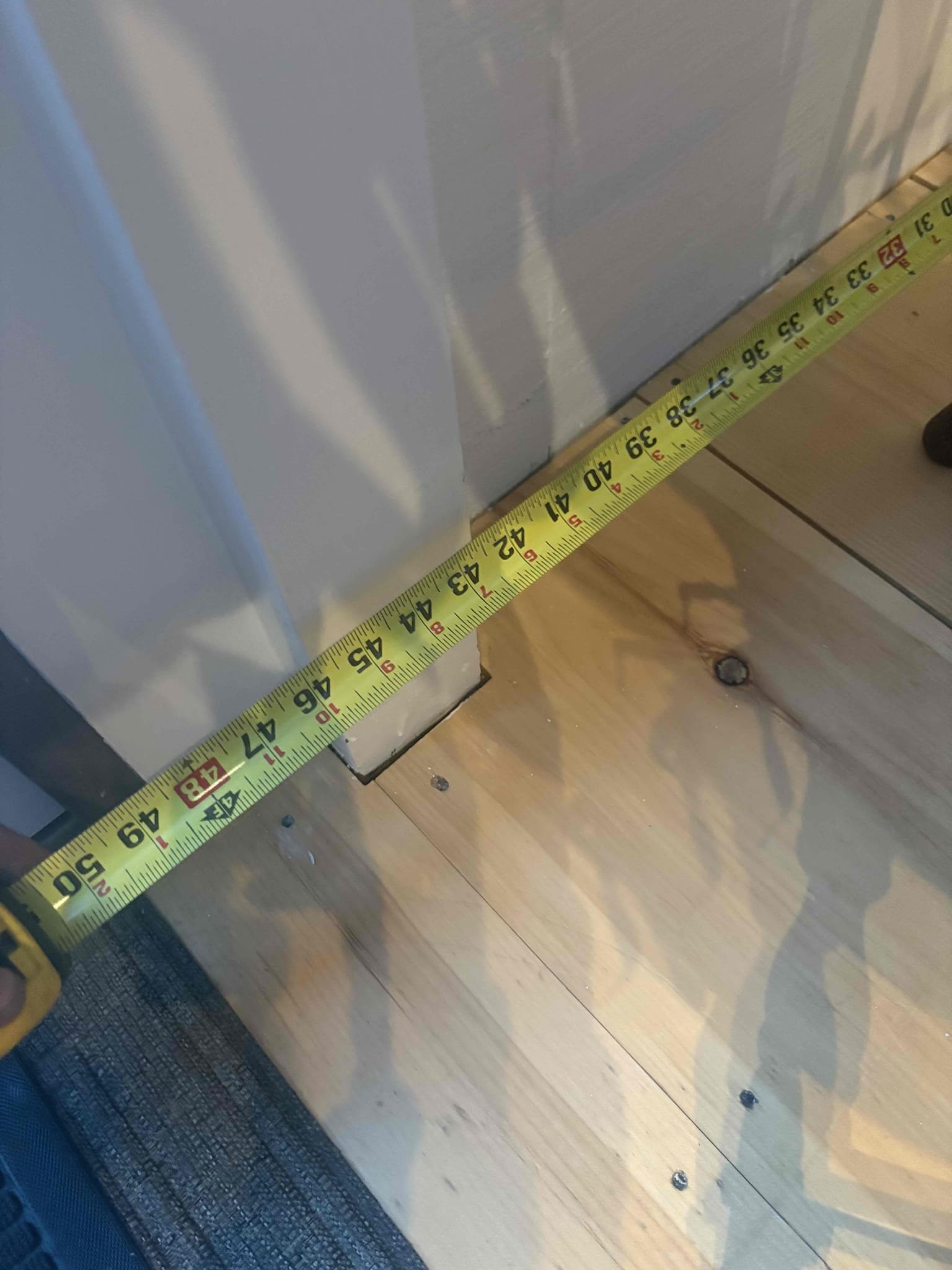 Responded to a report of a newly installed Peerless oil boiler not heating the home above 60°F.

Upon arrival, I confirmed proper operation of all three thermostats and began verifying system circulation. All supply and return piping at the boiler was hot; however, I identified multiple split loops within each zone and found three sections that were air-locked. The system was purged at the manifold and individually at each baseboard bleeder. After purging, I confirmed that all baseboard sections were hot and circulating properly. At this time, the boiler and all associated components are operating as designed.

The kitchen area is currently equipped with only one section of baseboard, located to the right of the front door. This single section is insufficient to adequately heat the combined kitchen and dining area, especially considering the loft space and open cathedral ceiling above. This issue is further compounded by seating and cabinetry obstructing proper airflow through the base