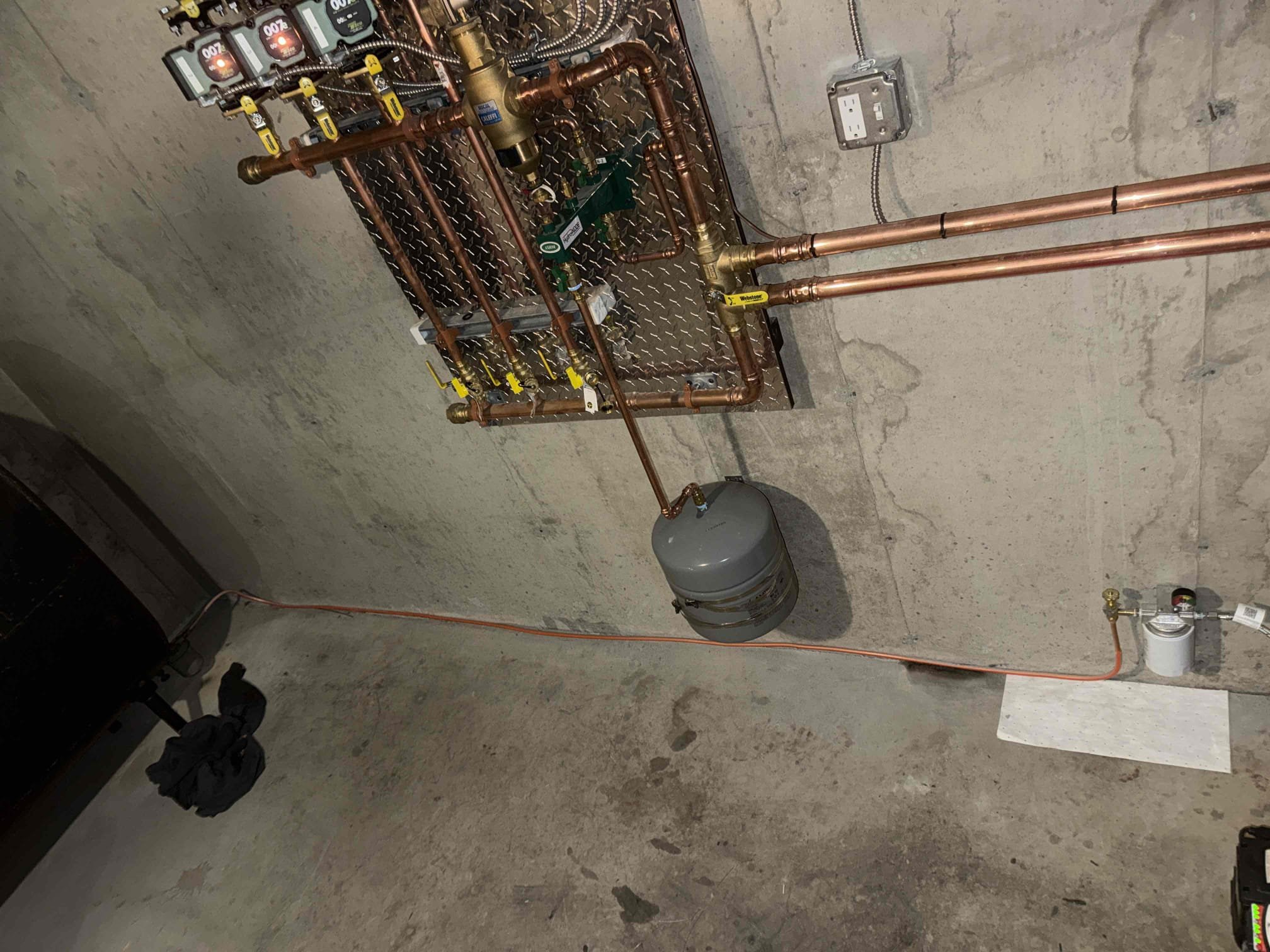 Removed the existing boiler and manifold. Installed a new Peer Pro Advantage oil-fired boiler, including new supply and return manifolds. Connected the new boiler to the existing zone piping. Installed a new smoke pipe to the existing chimney connector and added a draft regulator to the flue piping.

Ran a new oil supply line from the oil tank to the boiler due to leakage in the previous line. Installed a spin-on oil filter and flexible oil line compatible with the new boiler. Relocated and wired a new Firomatic safety valve for the boiler.

Performed full boiler startup, including verification of oil pump pressure and pump cutoff. Checked all system safeties and conducted combustion and draft testing. Confirmed the boiler is operating within manufacturer specifications.

Verified proper operation of the high-limit control and the water heater aquastat to ensure system shutdown upon satisfaction; both operated correctly. Reviewed new system safeties and operation with the customer. At 