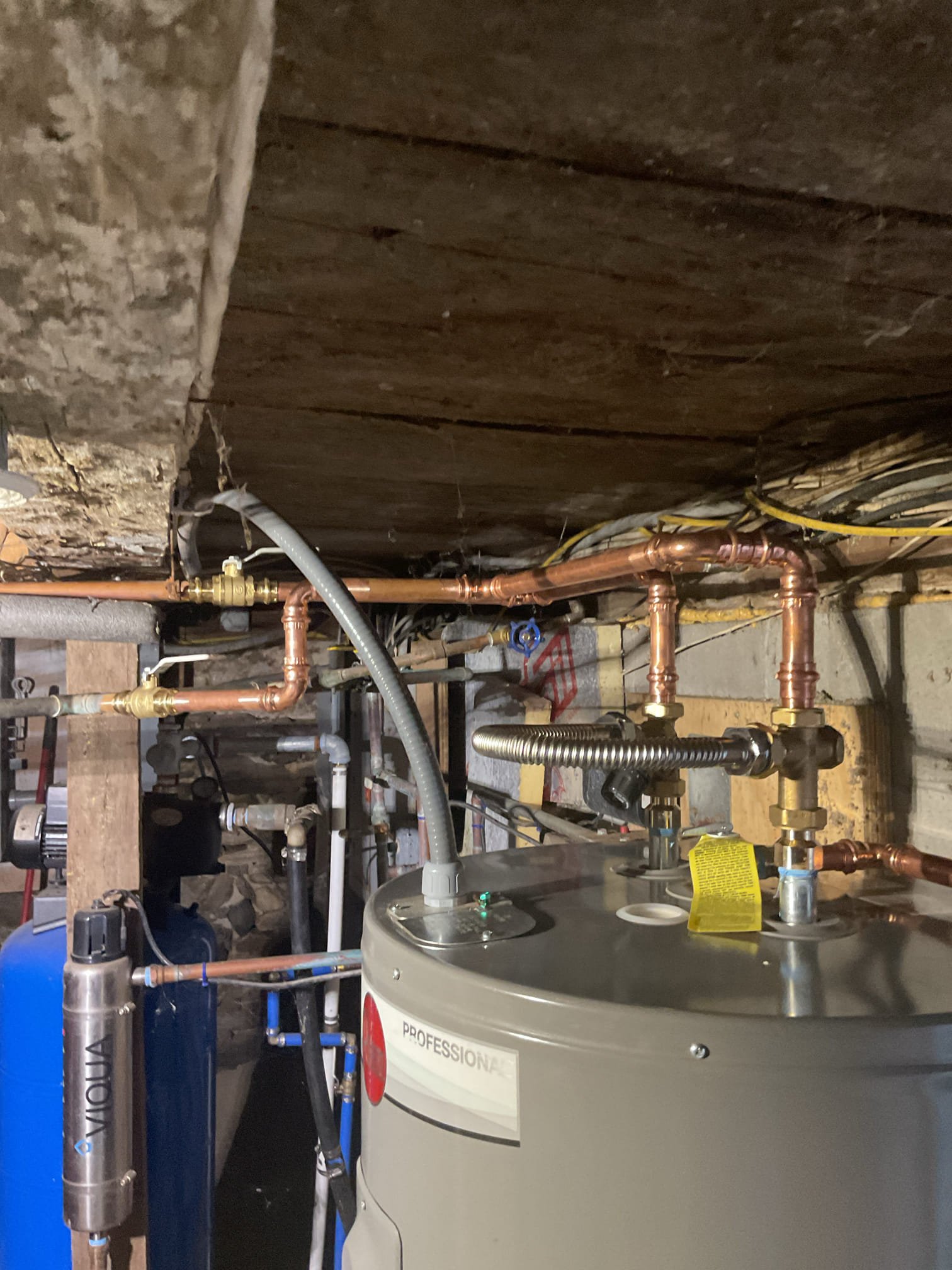 The homeowner’s existing water heater was not operating properly. We removed the existing 50-gallon electric water heater and installed a new Rheem Professional Series 50-gallon electric water heater.

A new thermostatic mixing valve was installed at the outlet of the water heater. Additionally, two new ¾-inch ball valves were installed—one on the cold-water supply and one on the hot-water outlet—to provide proper shutoff capability for the unit.

A liquid-tight electrical conduit was installed to protect the exposed wiring up into the ceiling joist, ensuring code compliance and improved safety.

The mixing valve was set to 4.5, which corresponds to approximately 120°F, in accordance with Vermont’s anti-scalding requirements. The internal thermostats of the water heater were set to 140°F to aid in the prevention of bacterial growth within the tank.

All piping connections were thoroughly inspected, and no leaks were found. At the completion of the installation, the system was tested an