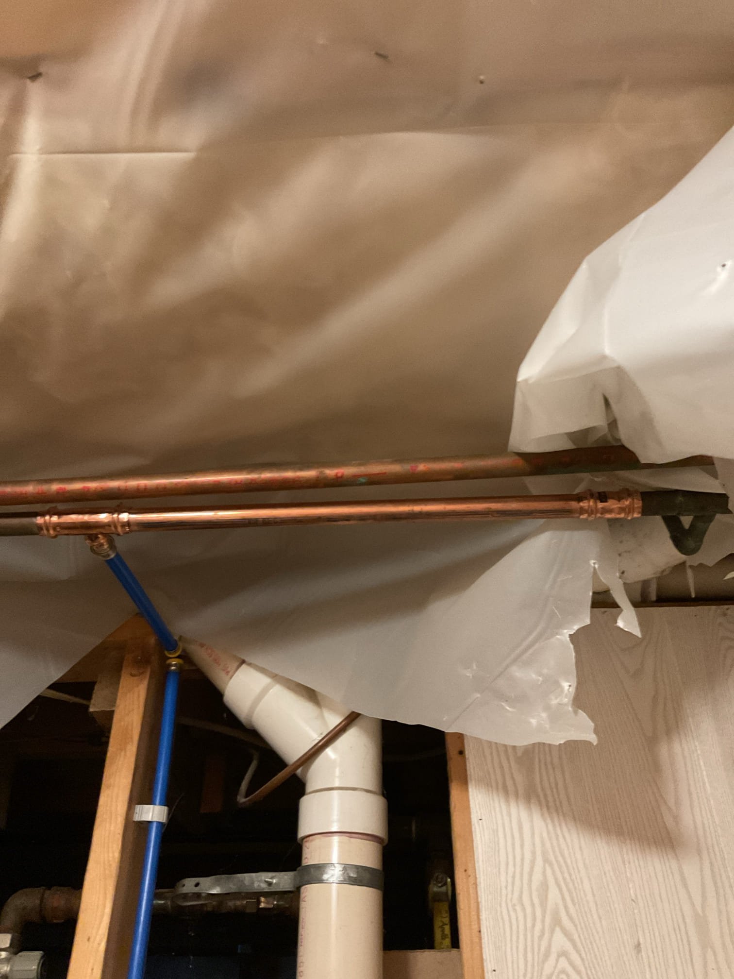 The existing plumbing system was found to require several upgrades to improve overall function, reliability, and serviceability. We proposed installing a customer-supplied utility sink with new PEX water supply lines, replacing the elevated toilet flange, repiping the toilet water supply, and removing the existing PVC ball valve and rubber coupling located in the ceiling. These improvements will help ensure a secure, leak-free plumbing system and provide long-term reliability and ease of maintenance.

Water was shut off to the home and the system was fully drained prior to work. The existing washer connection and copper toilet supply line were removed, along with the outdated ¾” water connection. A new tee was installed, and a new PEX water line was run to the toilet using a HoldRite bracket for proper support. PEX caps were installed to allow for drywall installation at a later time. New hot and cold PEX lines were also run to serve the utility sink, with all piping properly supported