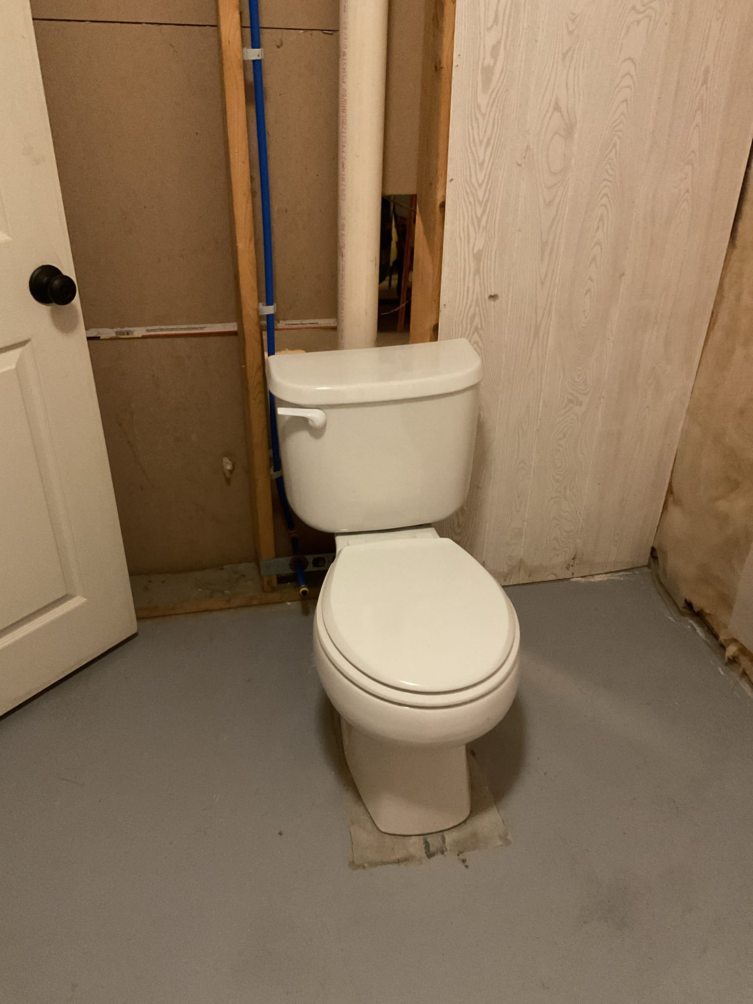 The existing plumbing system was found to require several upgrades to improve overall function, reliability, and serviceability. We proposed installing a customer-supplied utility sink with new PEX water supply lines, replacing the elevated toilet flange, repiping the toilet water supply, and removing the existing PVC ball valve and rubber coupling located in the ceiling. These improvements will help ensure a secure, leak-free plumbing system and provide long-term reliability and ease of maintenance.

Water was shut off to the home and the system was fully drained prior to work. The existing washer connection and copper toilet supply line were removed, along with the outdated ¾” water connection. A new tee was installed, and a new PEX water line was run to the toilet using a HoldRite bracket for proper support. PEX caps were installed to allow for drywall installation at a later time. New hot and cold PEX lines were also run to serve the utility sink, with all piping properly supported