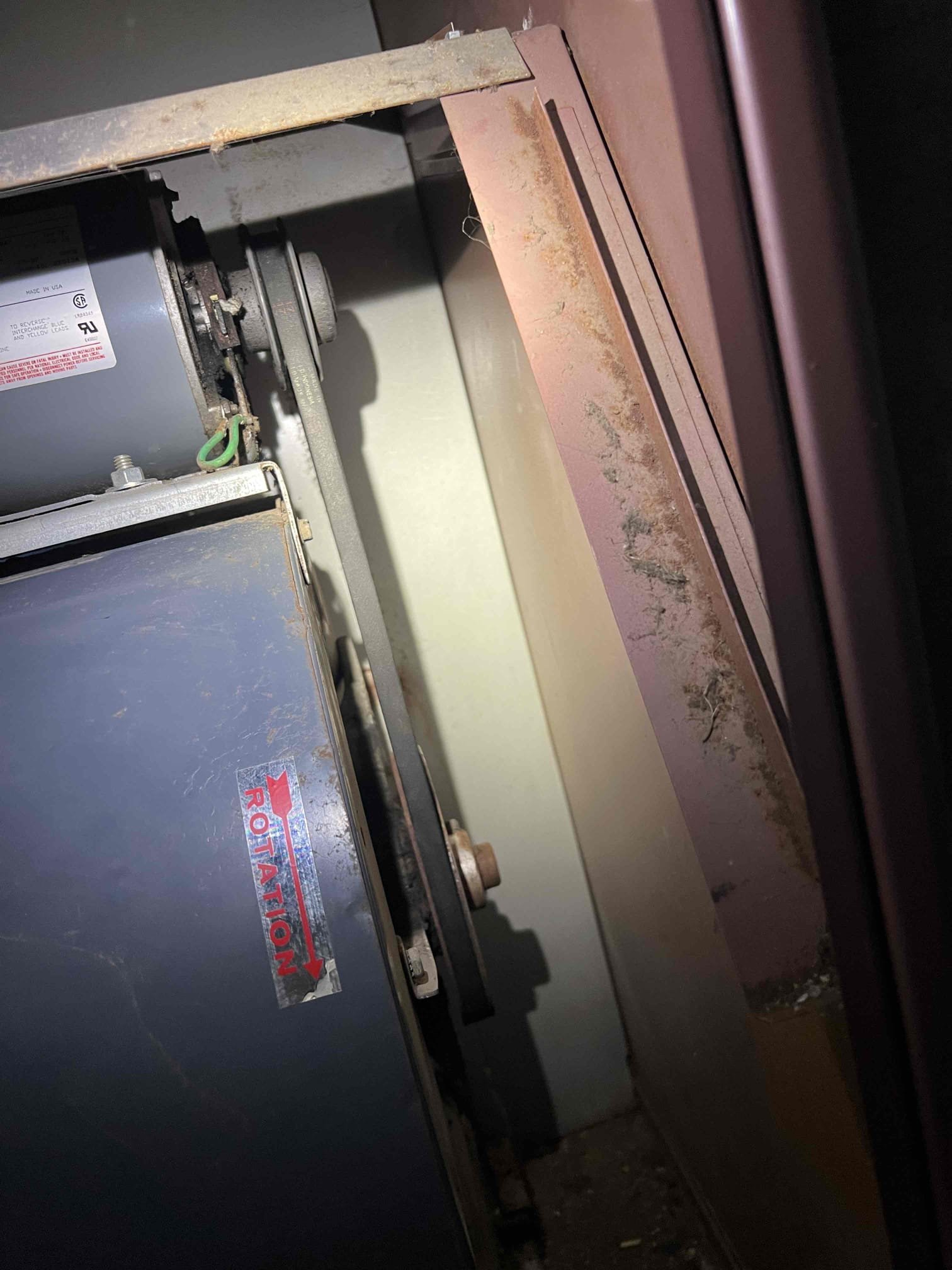 Arrived onsite to investigate a noise coming from an oil-fired furnace. Upon arrival, the furnace was running and the noise was audible upstairs. After inspecting the unit in the basement, I confirmed the noise was coming from the supply fan. Further inspection revealed a loose belt and a dead mouse in the squirrel cage.

I tensioned the belt and removed the mouse. The supply fan then operated normally. Verified operation, and the system is working properly at this time.