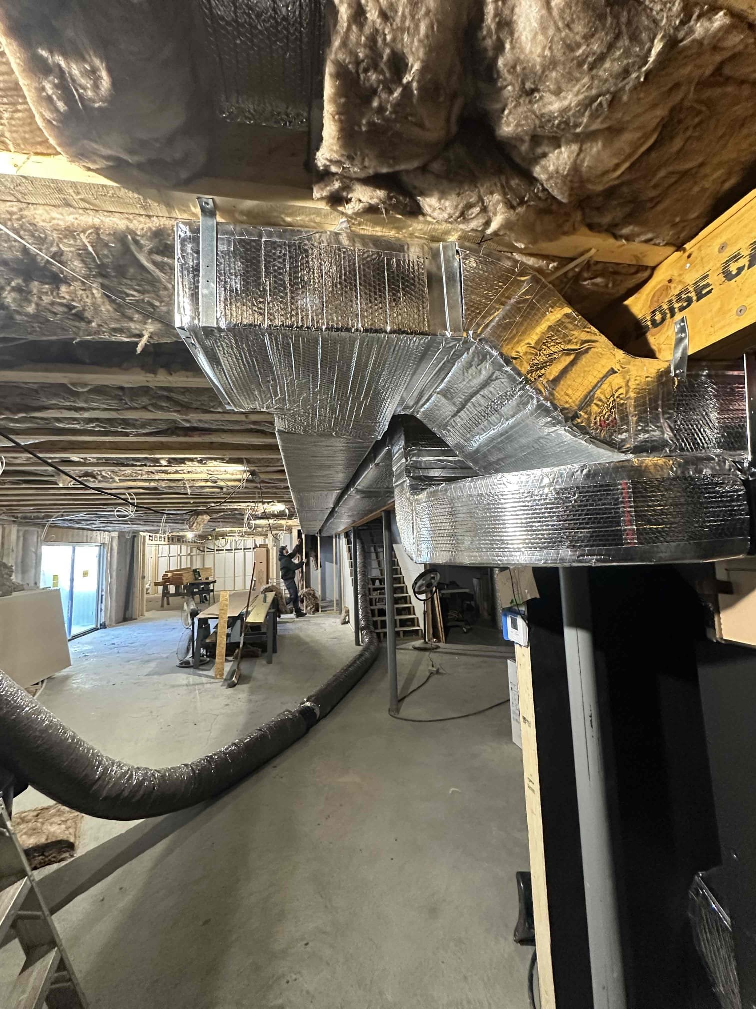 We roughed in a Mitsubishi 36K ducted Hyper heat pump for main floor. We installed supply and return plenums, register boxes, and connecting duct work. We will need to return to finish at later date.