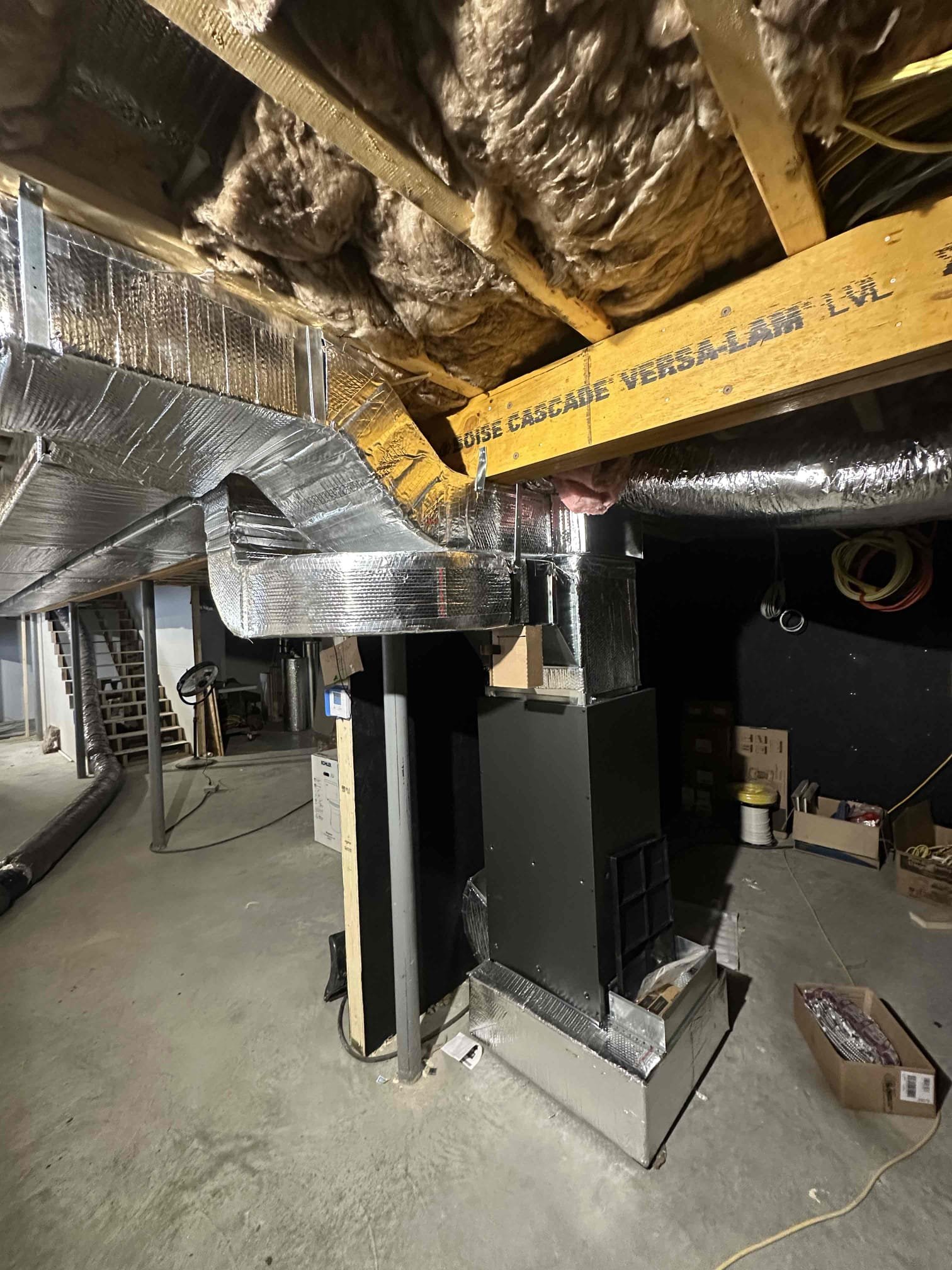 We roughed in a Mitsubishi 36K ducted Hyper heat pump for main floor. We installed supply and return plenums, register boxes, and connecting duct work. We will need to return to finish at later date.