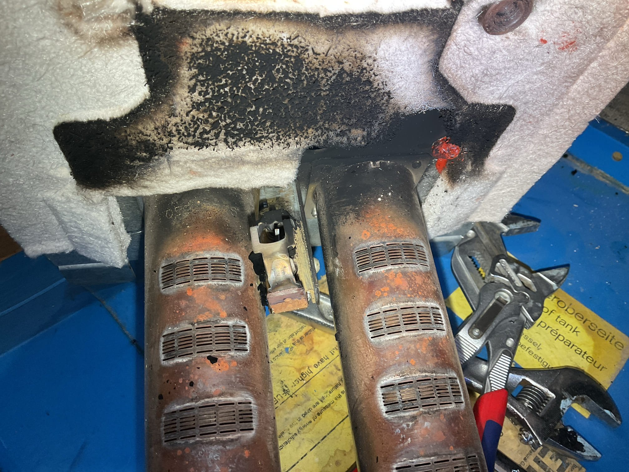 Arrived on site to diagnose boiler sooting up again. We provided an estimate to deep clean the heat exchanger. It was accepted so we disassembled the top of the boiler and removed the burners. We brushed the top of boiler and vacuumed it all out. We got as much soot out as we could with brush/vacuum before we rinsed the heat exchanger to get even more out. Once we got it as clean as possible, we dried it out and then reassembled the unit. Test fired the unit at the recommended gas pressure of 9.8”. The boiler refuses to burn cleanly at the recommended pressures. Set pressure back down to 5.15” and performed a combustion analysis. After running for a while the CO in the vent dropped to 2ppm. This is as clean as I can get the boiler to run. There are no other CO leaks or sooting anywhere that I can see. Ran the boiler for 35minutes or so while I was waiting on hold with buderus tech support. They kept telling me what the pressure should be and eventually I got transferred to someone else