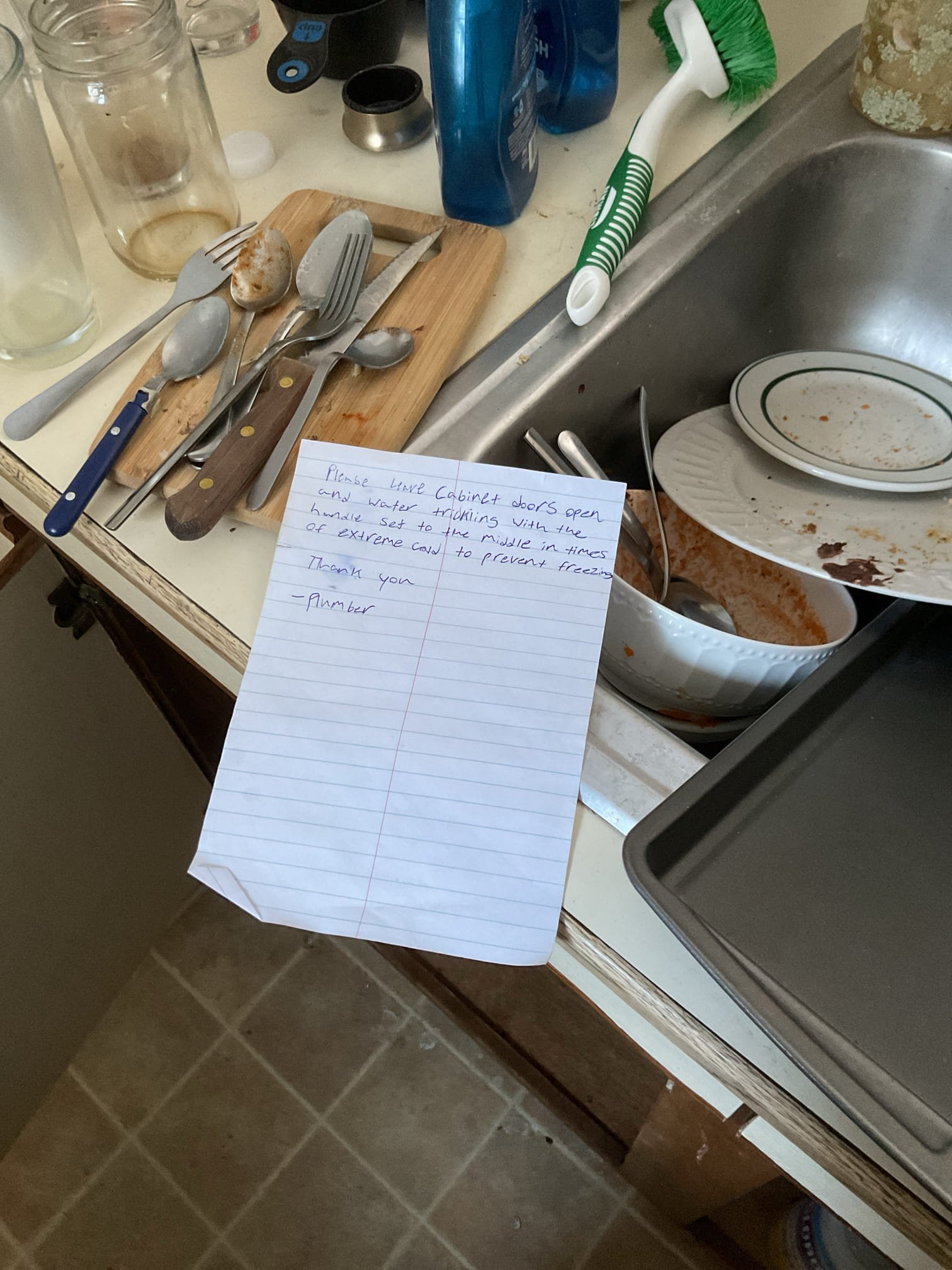 Customer had lost water at the kitchen in their rental. Pipes were frozen. After locating the frozen pipes I turned the water on and used my heat gun to send heat to frozen sections of pipe. The cold side gave way first with the hot dripping. I ran hot water at the lav faucet to get hot water into the pipes. I then continued with the heat gun until it gave way as well. 

I then used my camera to check for leaks and opened and closed the apartment shutoff to test for leaks. I did not see any signs of a broken pipe. 

The basement door was not latching allowing a draft. I reamed out the latch hole in order to allow the door to close and as a courtesy I used some nails and hung up a drop cloth over the door to stop the draft. I was unable to fit into the space to put insulation on the pipe. 
