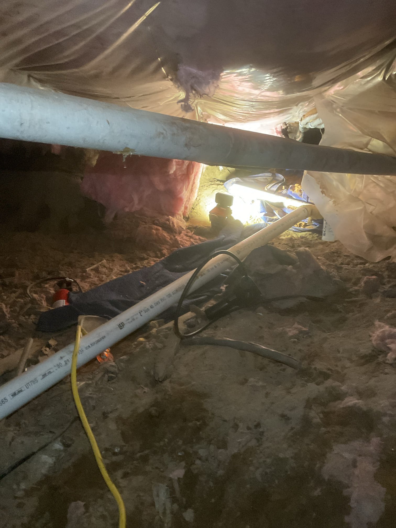 Customer had lost water at the kitchen in their rental. Pipes were frozen. After locating the frozen pipes I turned the water on and used my heat gun to send heat to frozen sections of pipe. The cold side gave way first with the hot dripping. I ran hot water at the lav faucet to get hot water into the pipes. I then continued with the heat gun until it gave way as well. 

I then used my camera to check for leaks and opened and closed the apartment shutoff to test for leaks. I did not see any signs of a broken pipe. 

The basement door was not latching allowing a draft. I reamed out the latch hole in order to allow the door to close and as a courtesy I used some nails and hung up a drop cloth over the door to stop the draft. I was unable to fit into the space to put insulation on the pipe. 
