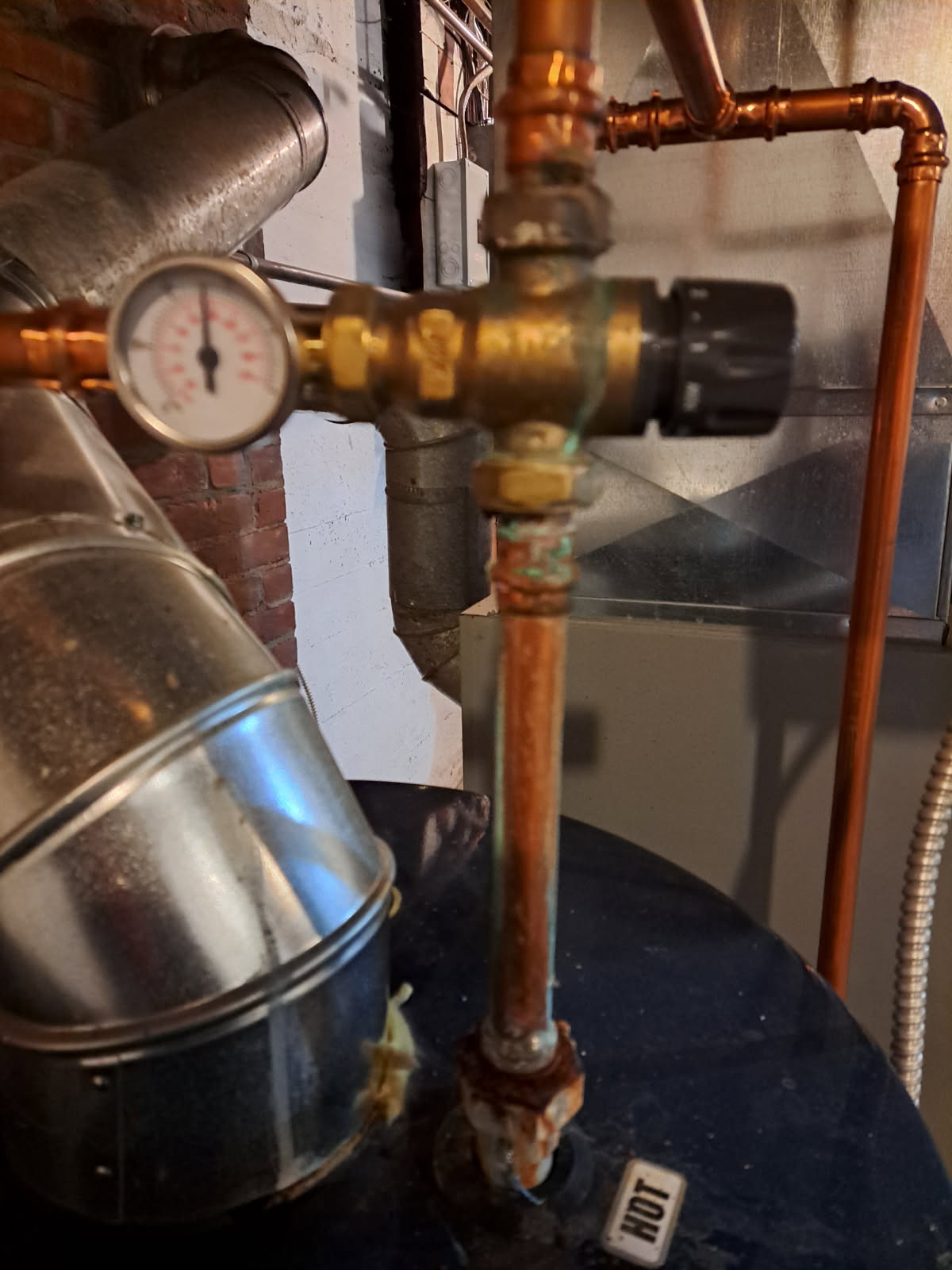 Arrived on site to inspect mixing valve that seems to be corroding. After our initial inspection, we found that a couple of the seals on the mixing valve had been leaking slowly causing a buildup of oxidation. We tightened each of the nuts on the mixing valve. The one that connected the valve to the water heater was a little loose. We then ran water and found no signs of any more leaks. We did not opt to replace the valve at this time due to it only being a year old. Tightening the union nuts was the first attempt to resolve the problem before replacement. Informed Katie that she should keep an eye on it in the future. If it continues to leak in the future , replacement may be necessary.

During our visit, we also found that the elbow coming off of the vent was not properly secured to the water heater and there were two holes that was allowing exhaust fumes to escape into the basement. We were not able to push the elbow down further so we applied some metal tape to cover the holes.

Ev