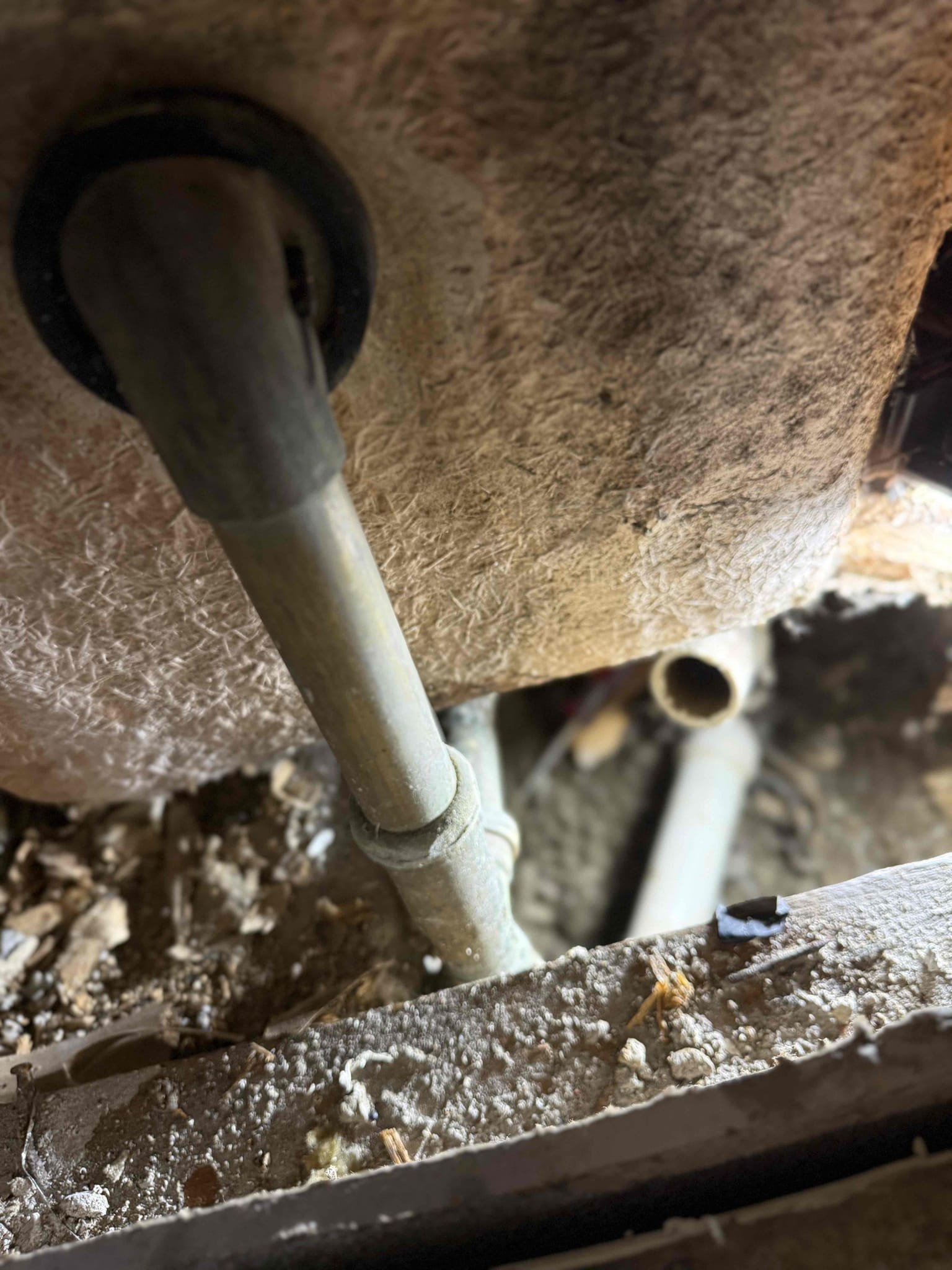 Upon inspection, we located a leak beneath the bathtub and determined that the standpipe connecting the tub waste assembly to the trap had become disconnected, allowing water to drain directly into the surrounding area. The existing components were in poor condition and not properly secured. At this time, we informed the customer that we will need to return at a later date to remove and replace the tub waste assembly and P-trap to ensure a proper, secure connection and restore correct drainage function.