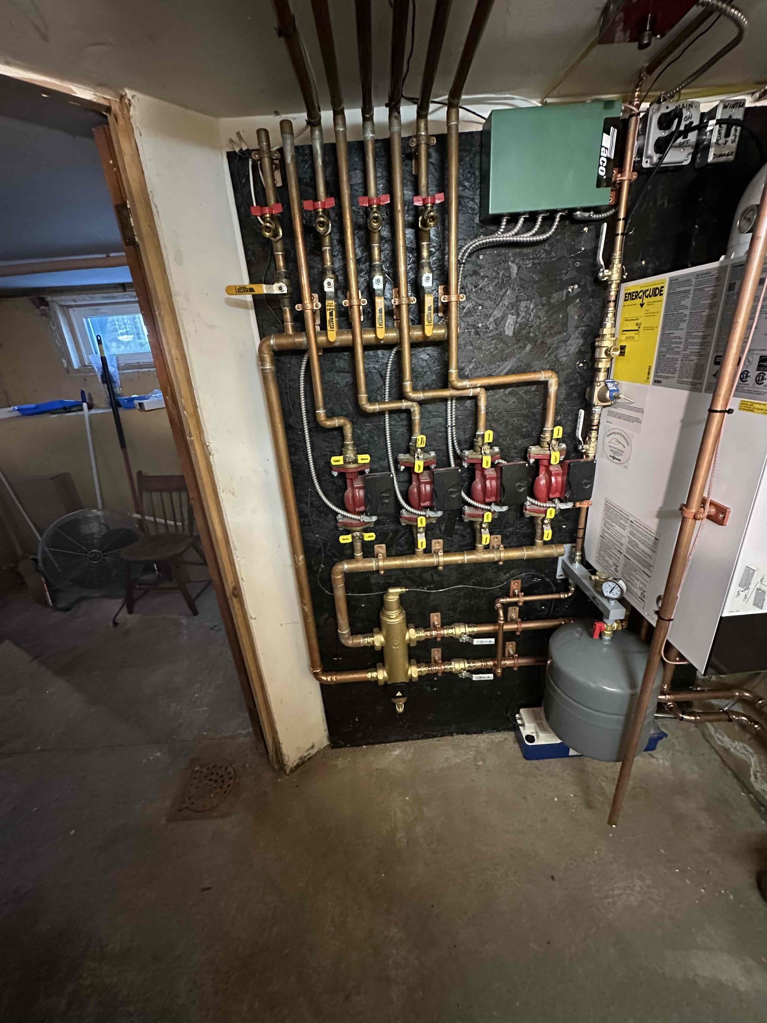 I removed the existing boiler and indirect water heater along with all associated venting and components, and installed a new Viessmann Vitodens 100 propane boiler and a Rheem indirect water heater. The new boiler was connected to the existing heating manifold, and the gas line was connected and tested with a bubble test and full leak check to confirm there were no leaks. All connections were verified secure.

A condensate pump was installed to neutralize and discharge condensation from the boiler to the washing machine drain. The gas shutoff and water shutoff valves were clearly labeled. New concentric venting was installed from the boiler to the exterior of the home. The venting was properly supported with hangers, and all penetrations were sealed with spray foam, furnace cement, and silicone to ensure an airtight and weather-tight seal.

A mixing valve was installed on the indirect water heater. The indirect water heater was set to 140 degrees, and the mixing valve was set to delive