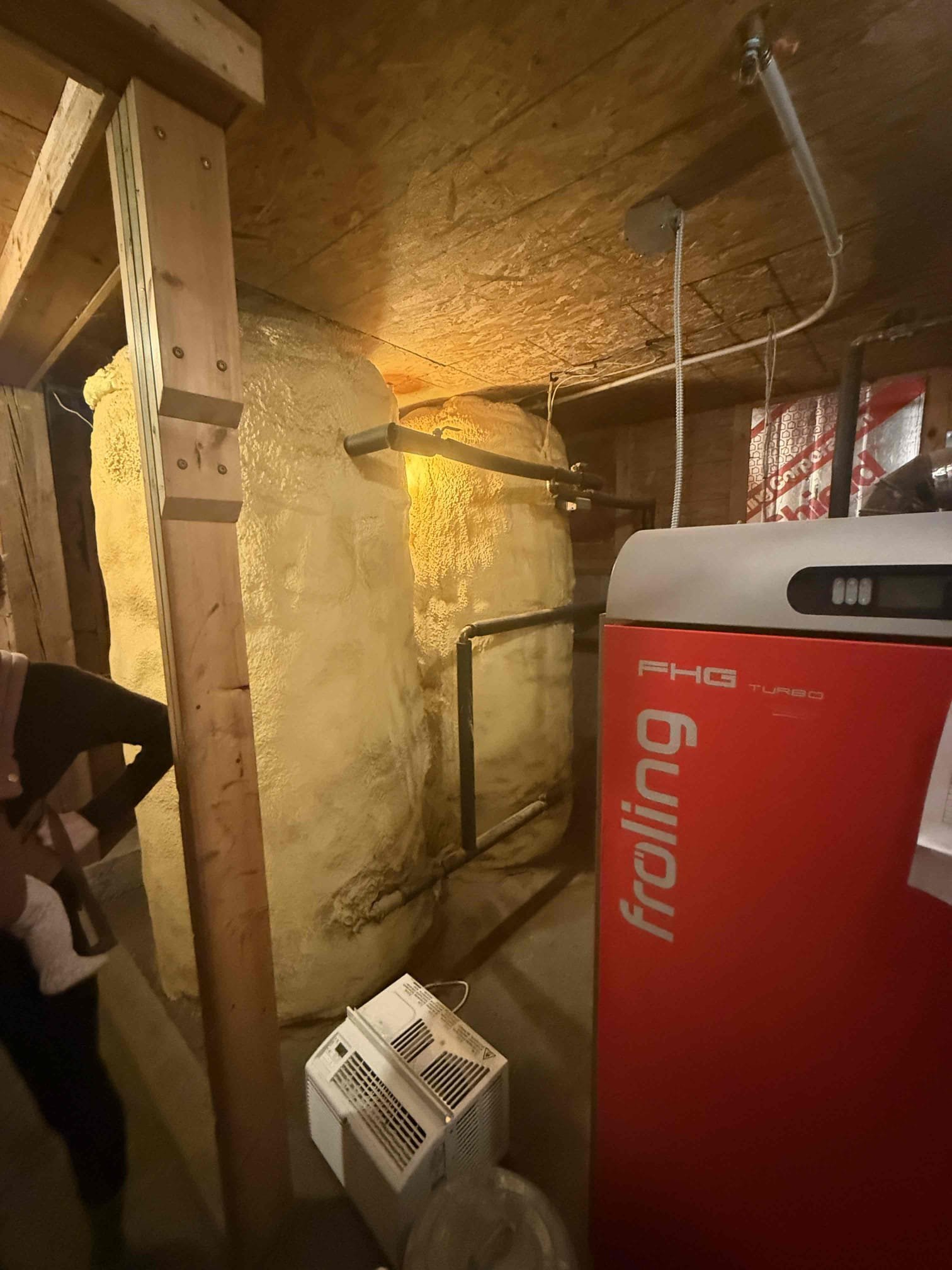 Customer reported insufficient heat in the first-floor master bedroom.

Upon inspection, I found the oil-fired Viessmann boiler supplying multiple cast-iron radiator hot water loops throughout the home. The system is also piped into a separate mechanical room with an additional manifold and large storage/storage buffer tanks connected to the boiler.

Based on system layout, heating load, and current performance, the oil-fired Viessmann boiler appears undersized for the overall demand of this home when operating as the sole heat source. The boiler is running and attempting to satisfy all zones; however, due to the size of the residence and the number of heating loops, it is likely at or beyond its effective capacity. This would explain the lack of heat in certain areas, including the first-floor master bedroom.

Customer reported oil usage of approximately 250 gallons every two weeks. They also stated that the previous owners relied heavily on the wood boiler system and used minimal oil