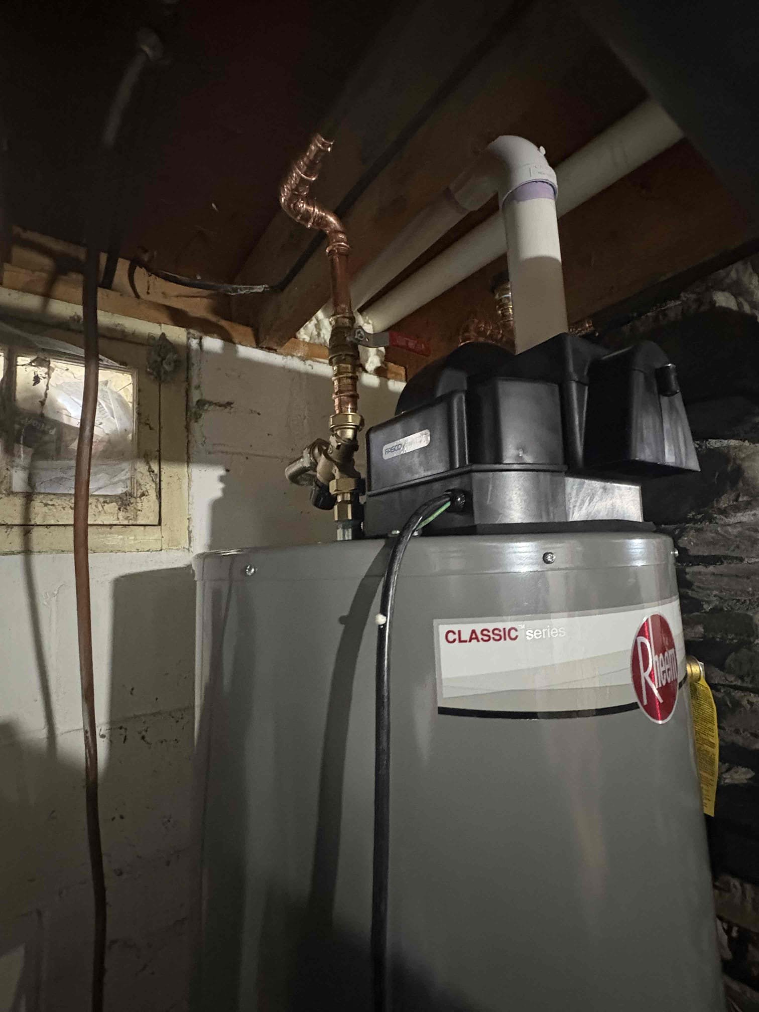 Removed the existing propane water heater and installed a new 40-gallon Rheem power-vented water heater. The old tank was disconnected and removed, and new hot and cold water piping connections were installed. A thermostatic mixing valve was added and set to 120°F, and the water heater temperature was set to 140°F.

All gas piping connections were leak tested and bubble tested, and no leaks are present at this time. An electrical outlet will need to be installed to supply power to the power vent unit. The tank has not yet been filled, and the gas supply to the unit remains shut off until power is provided and final startup can be completed.