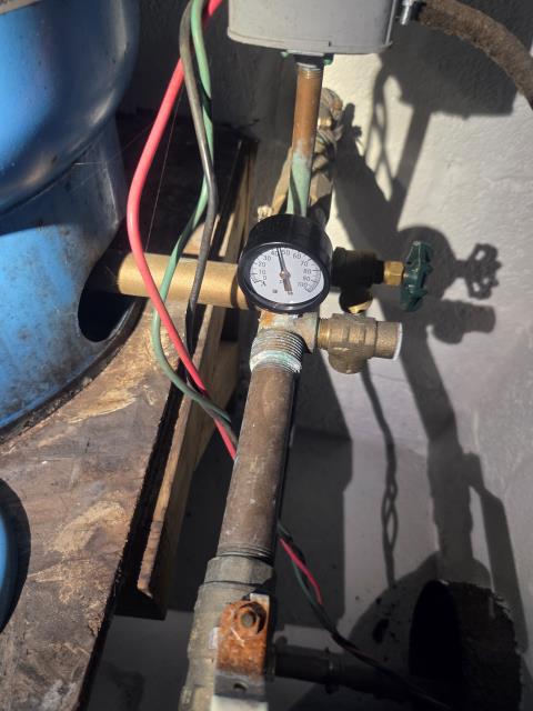 The well pump is functioning properly; it is able to maintain a bathroom faucet and shower running while still pumping up to 60 psi and is shutting off as it should. The 32-gallon well tank has a proper 38 psi of air and is draining and filling at the proper times. The 40/60 psi pressure switch is functioning correctly and contacts look like they are in good condition. The check valves are all holding; there are no signs of leak back or air at all. The older type of fuse box for the well isn't ideal, but it is in proper working order. Based on the amps of the well pump, it's most likely a 230v 1/2HP 2-wire pump, and it's producing about 7 gallons per minute easily.
- Regarding the well system, everything seems to be in good working order at this time with no signs of issues; there is slight corrosion on the tank tee, but that is not concerning. Took water sample to test 