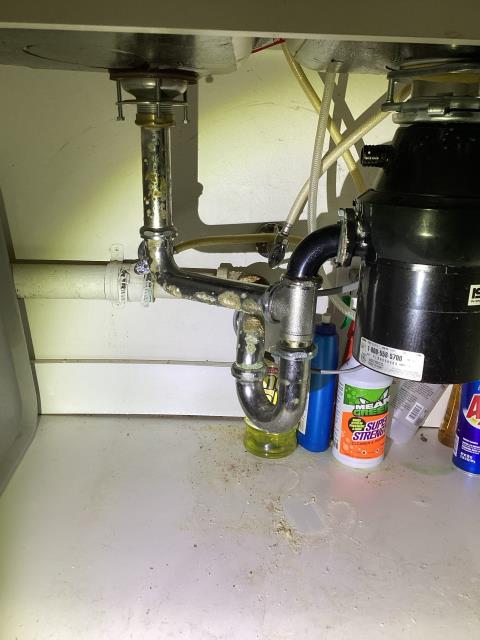 JIG Plumbing extracted the wastewater from the double-basin kitchen sink, which was holding water. We removed the existing stainless steel P-trap and cabled the kitchen's secondary drain line to clear the obstruction. Once the drain was successfully cleared and proper flow was restored, we replaced all tubular drain piping beneath the kitchen sink, as the existing tubular components were old and corroded.

JIG Plumbing recommended replacing the garbage disposal, as it was frozen and non-operational.