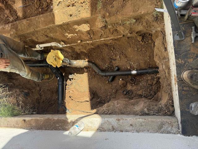 We rerouted kitchen and laundry drains, installed a new drain line, and replaced the water heater. We sawed and removed concrete, bored a new pathway, and tested the system.