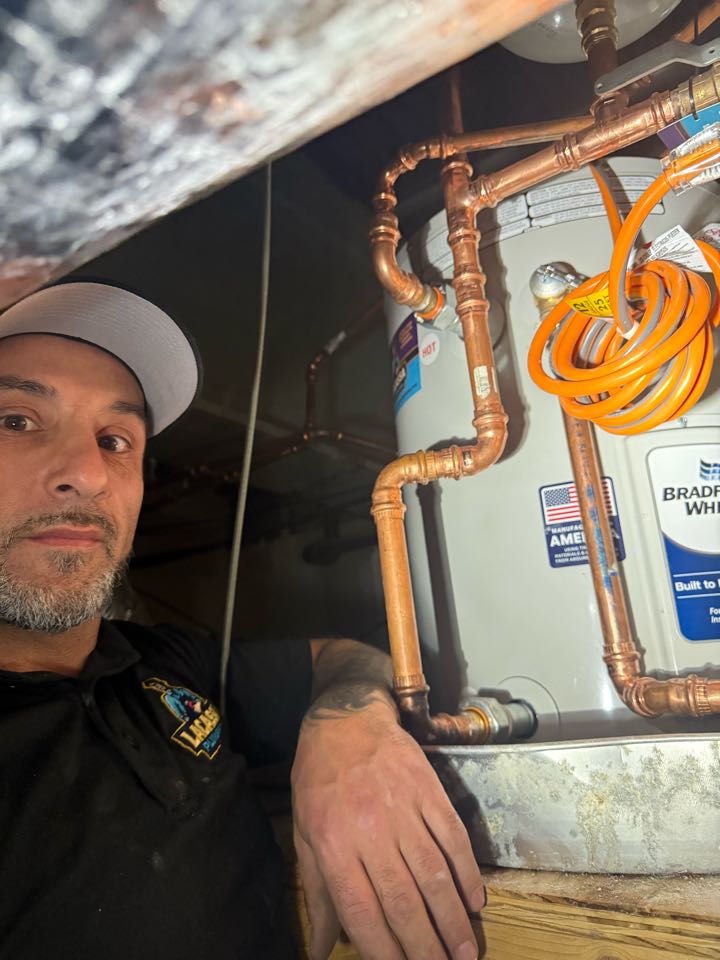 Installed vacuum breaker and expansion tank on water heater in ceiling at commercial property in Naperville 