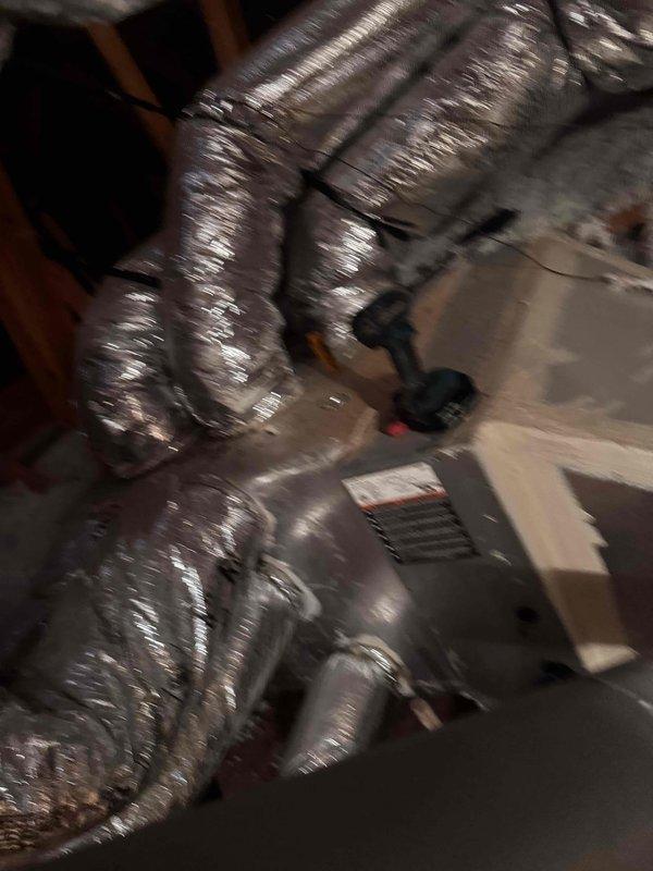 Performed spring maintenance service on a 10-year-old HVAC system located in the attic. Conducted electrical diagnostics using clamp meter, detecting normal amperage readings of 0.91A. Inspected and verified proper installation of flexible ductwork connections to the air handler unit.